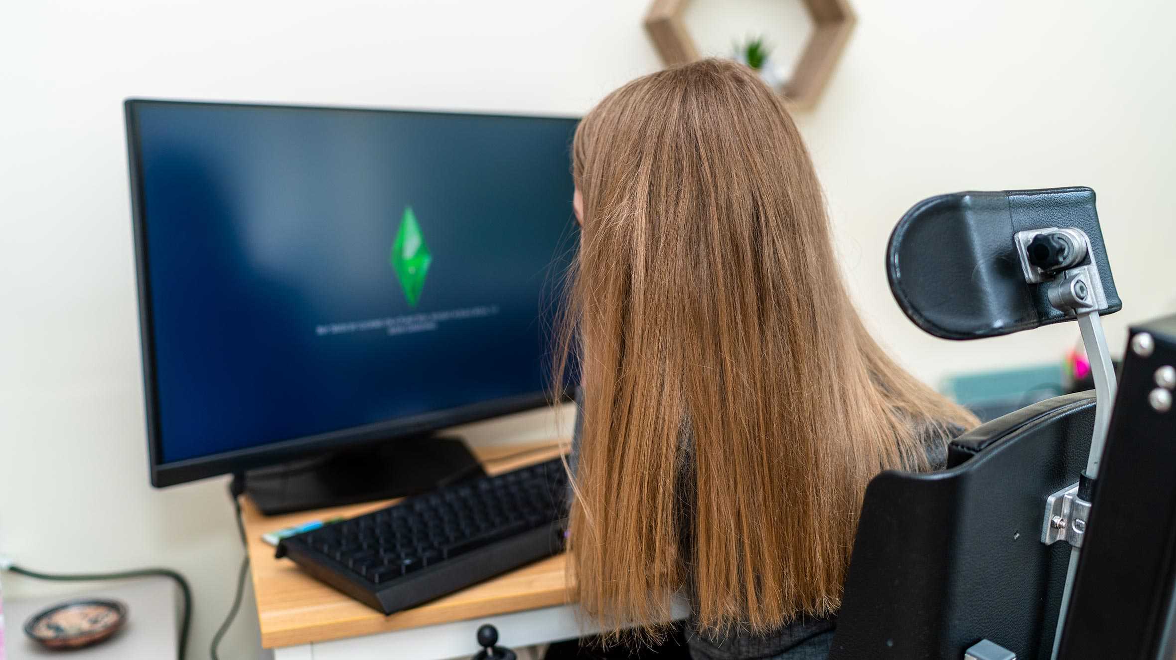 Sophie using her new gaming PC, facing away from the camera.
