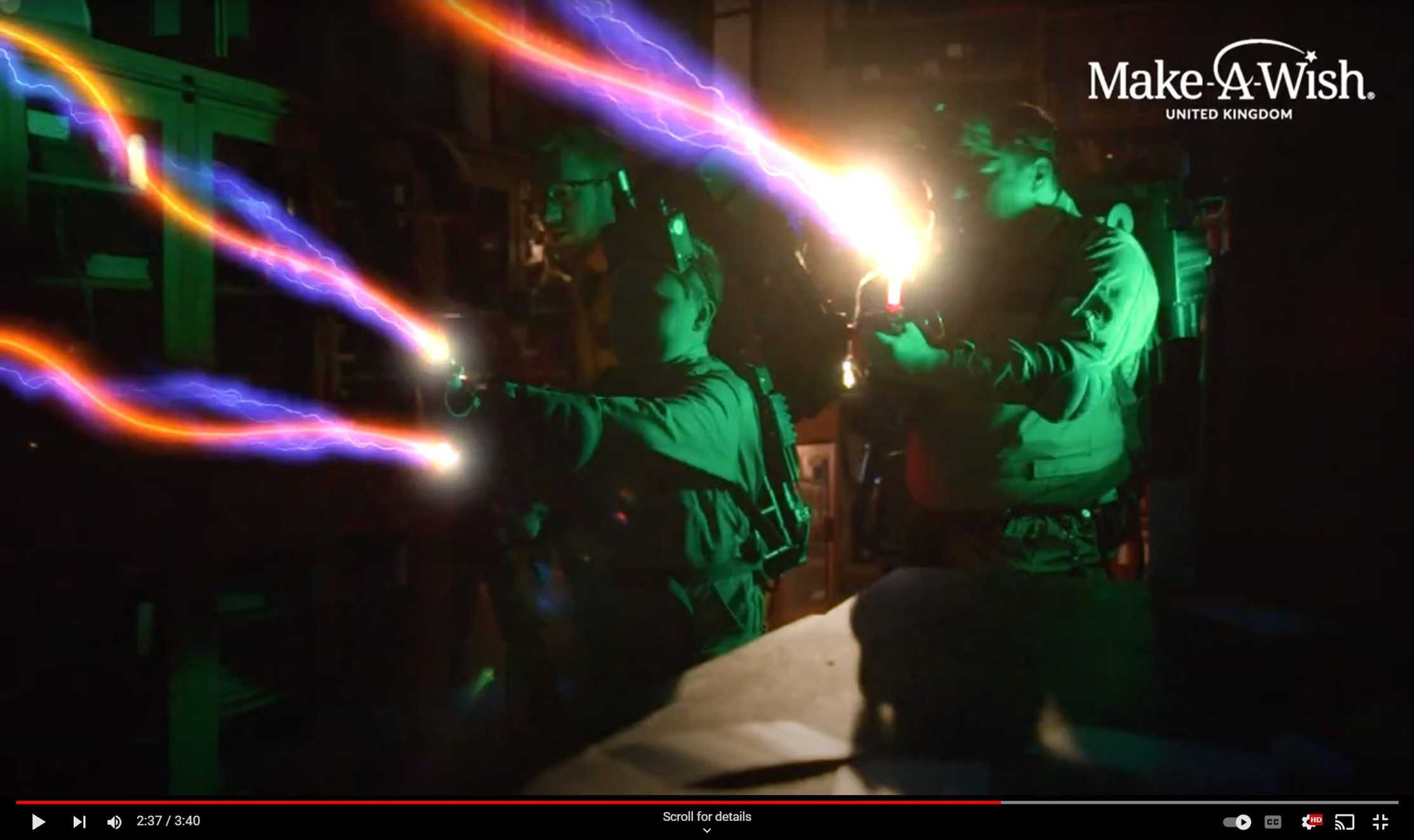 A still from the film of George's wish, showing him firing a proton beam from his Proton Pack.