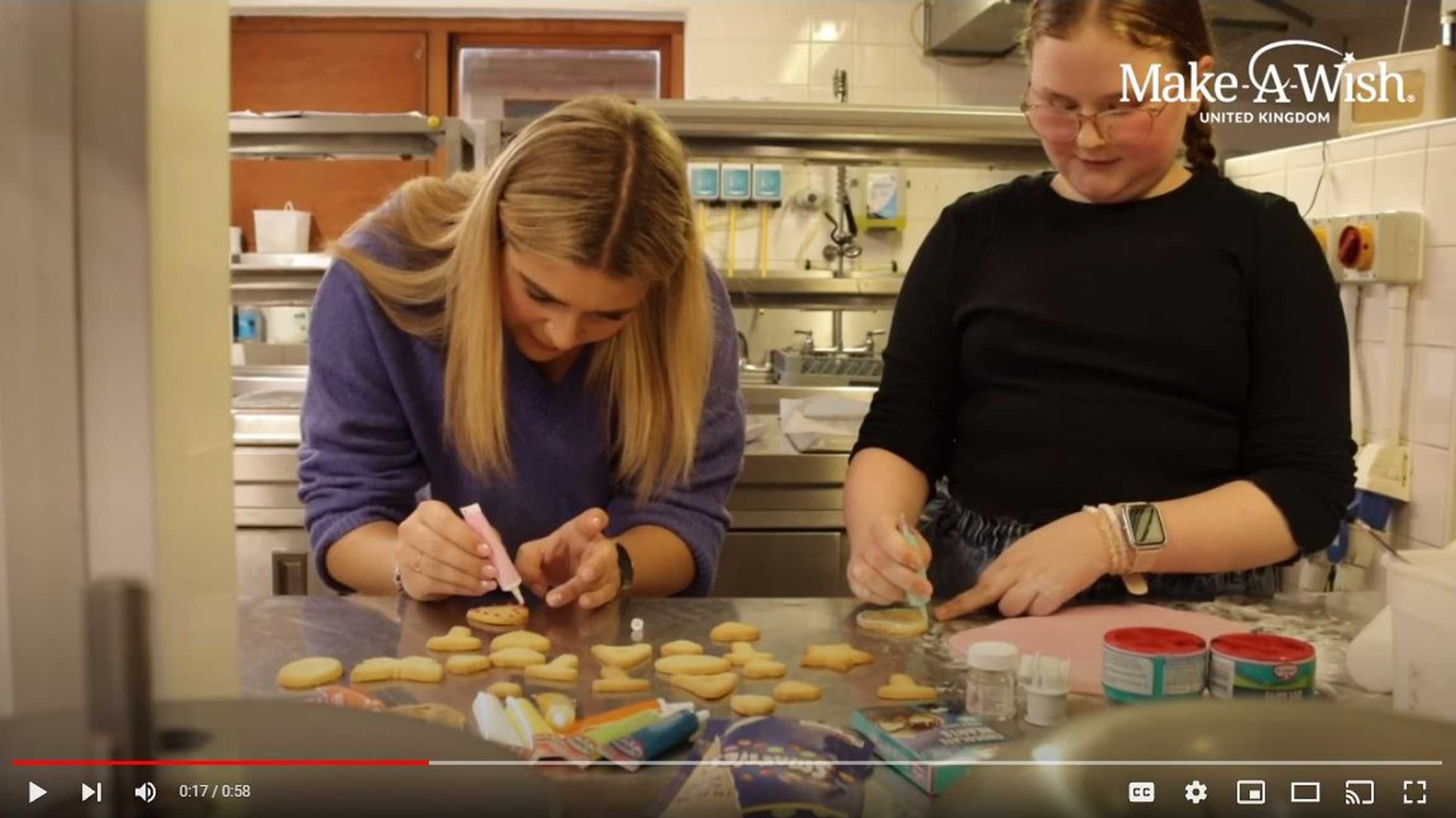 Abbie and Tilly icing some cookies they baked together.