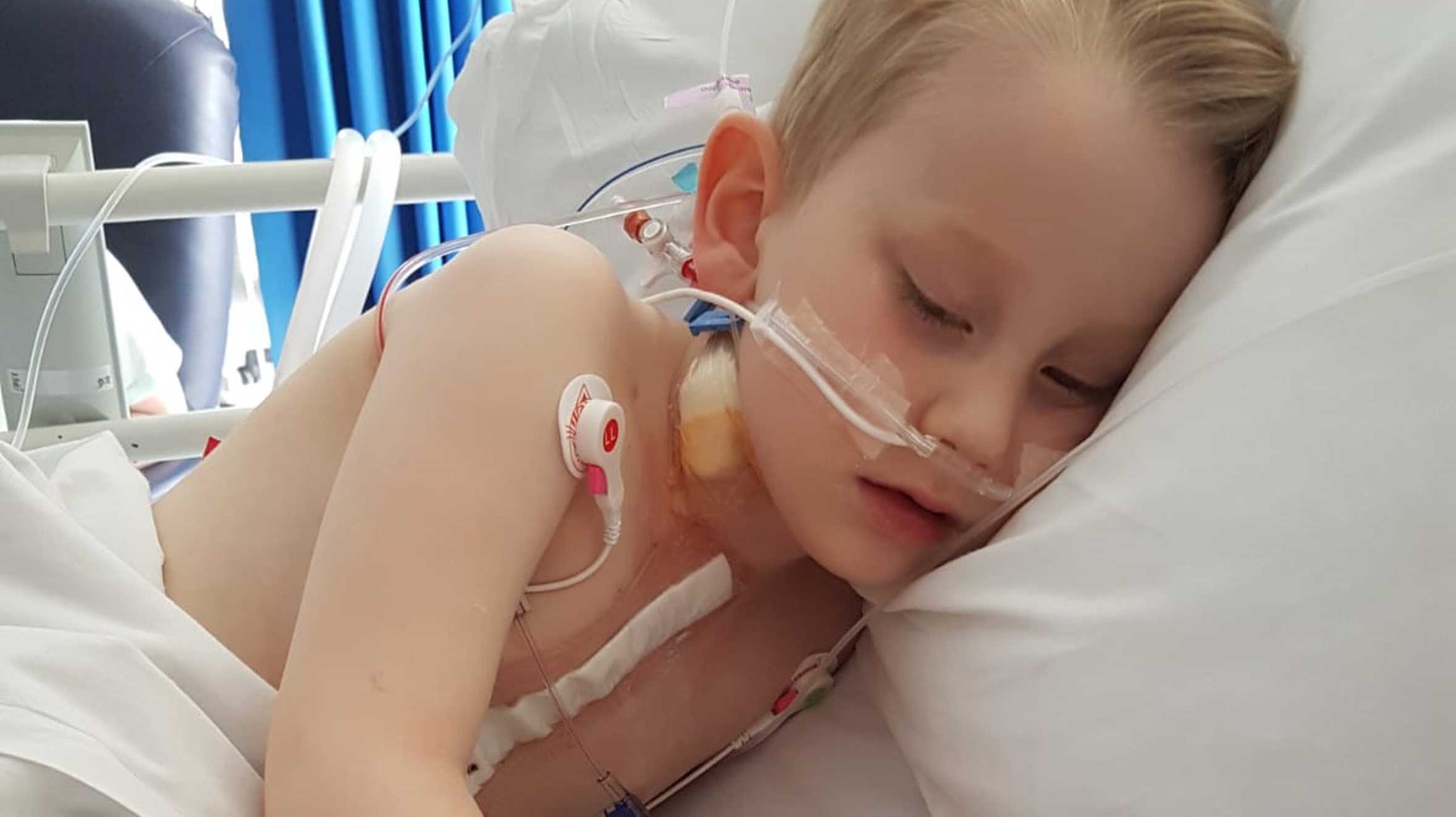 Louis asleep in his hospital bed, connected to breathing apparatus