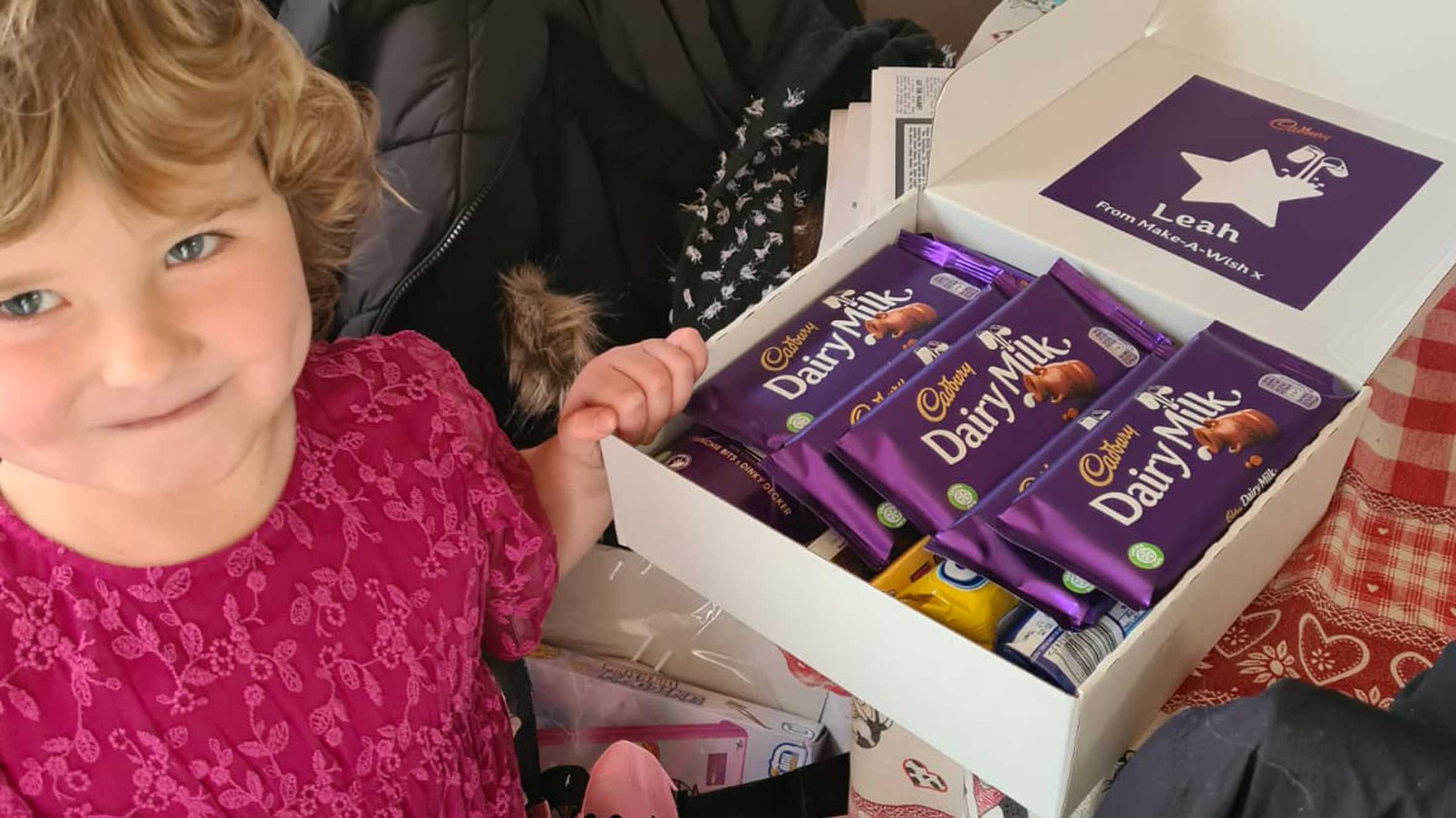Leah , looking very happy with a big box of chocolate bars.