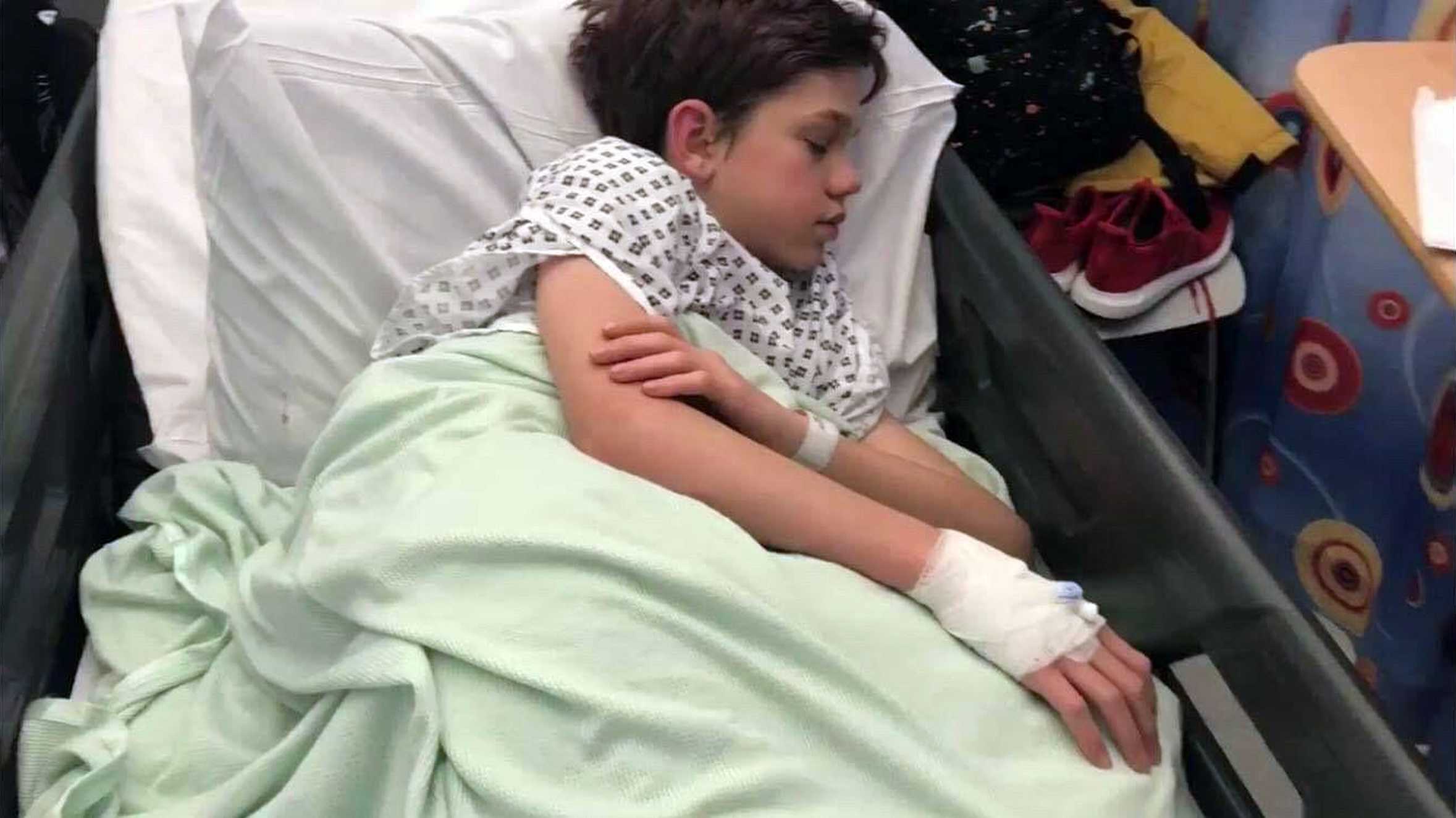 Wish child Sam, sleeping in his hospital bed during treatment for his condition.