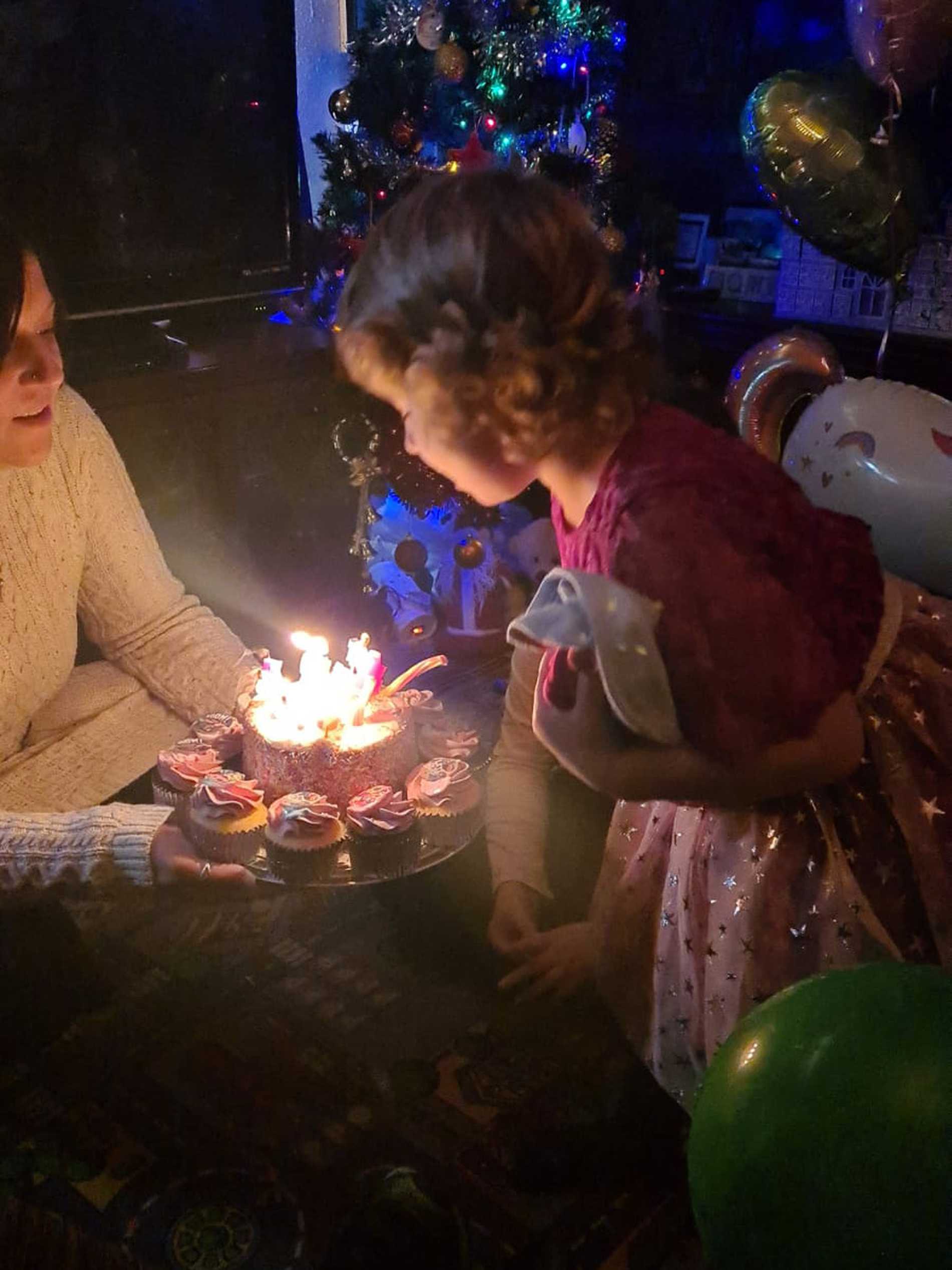 Leah blowing out the candles on her birthday cake.