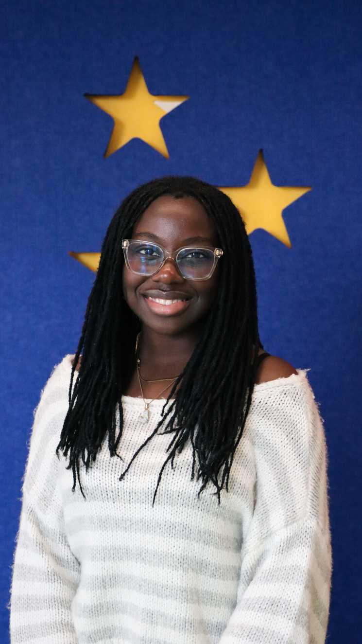 STARboard member Joanna is smiling at the camera, she is wearing glasses.