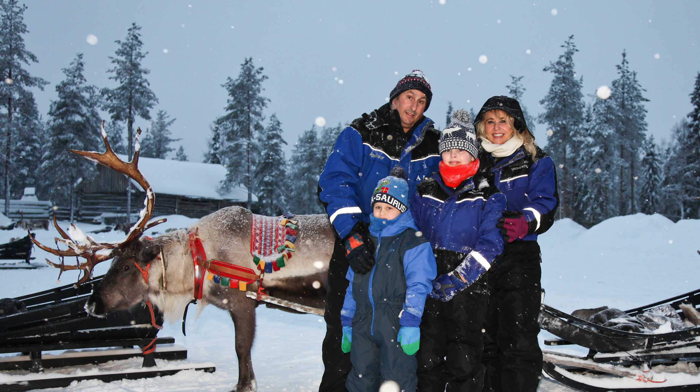 Finn with his family in Lapland with a reindeer