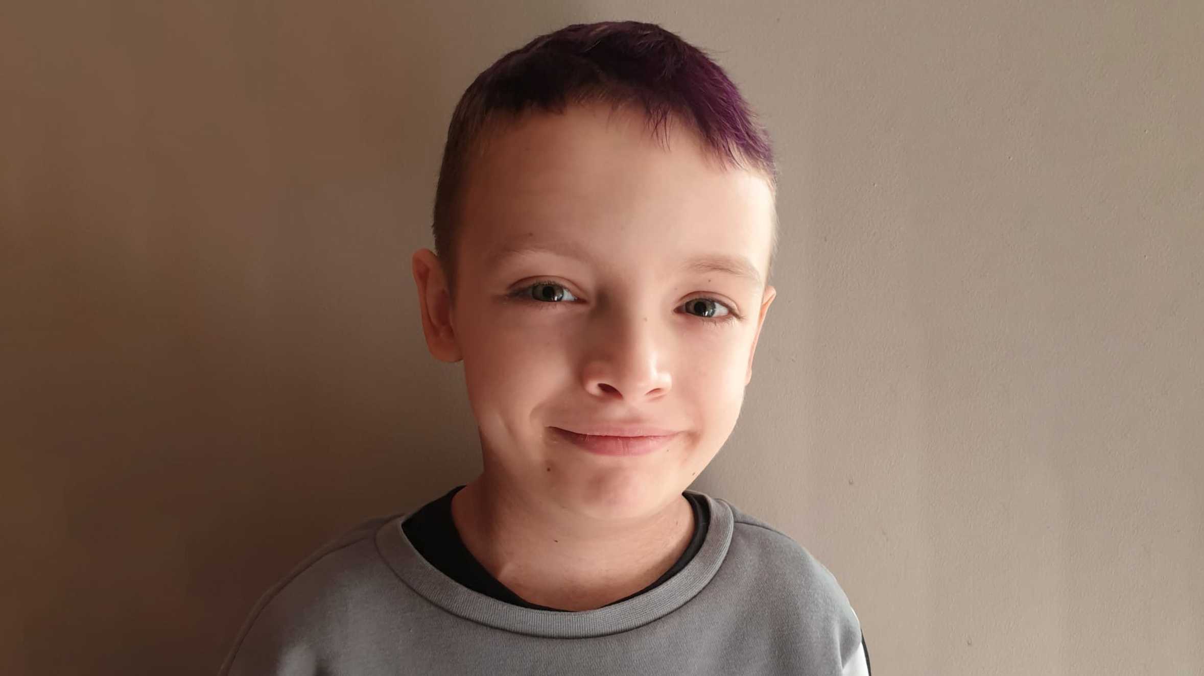 A portrait of wish child, McKenzie with his hair dyed purple.