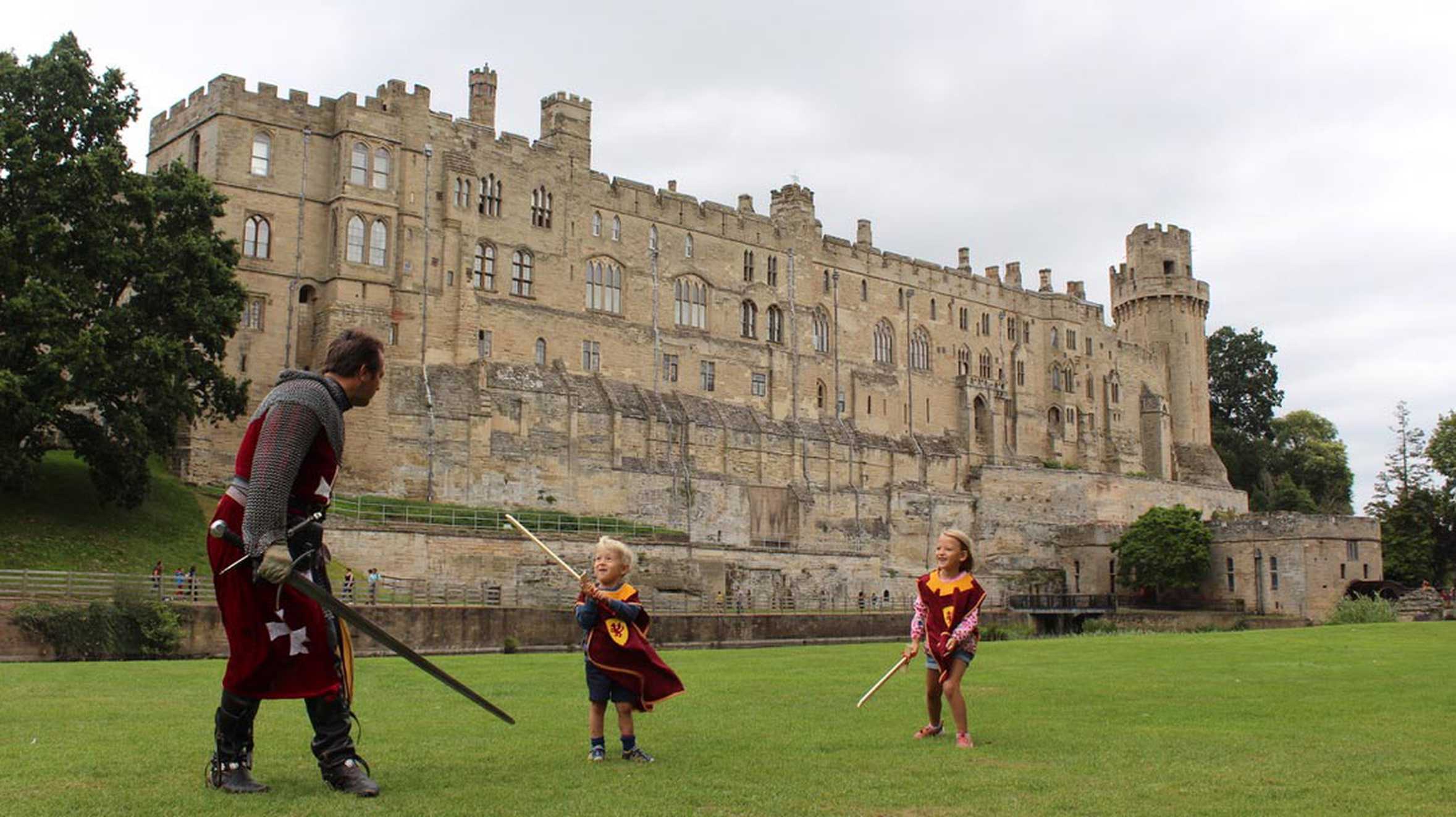 Hunor and his sister, Dorka fighting a knight with Warwick Castle in the background.
