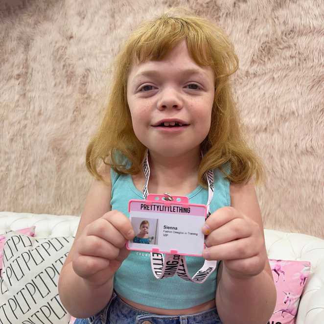 Sienna proudly holding her PrettyLittleThing VIP pass.