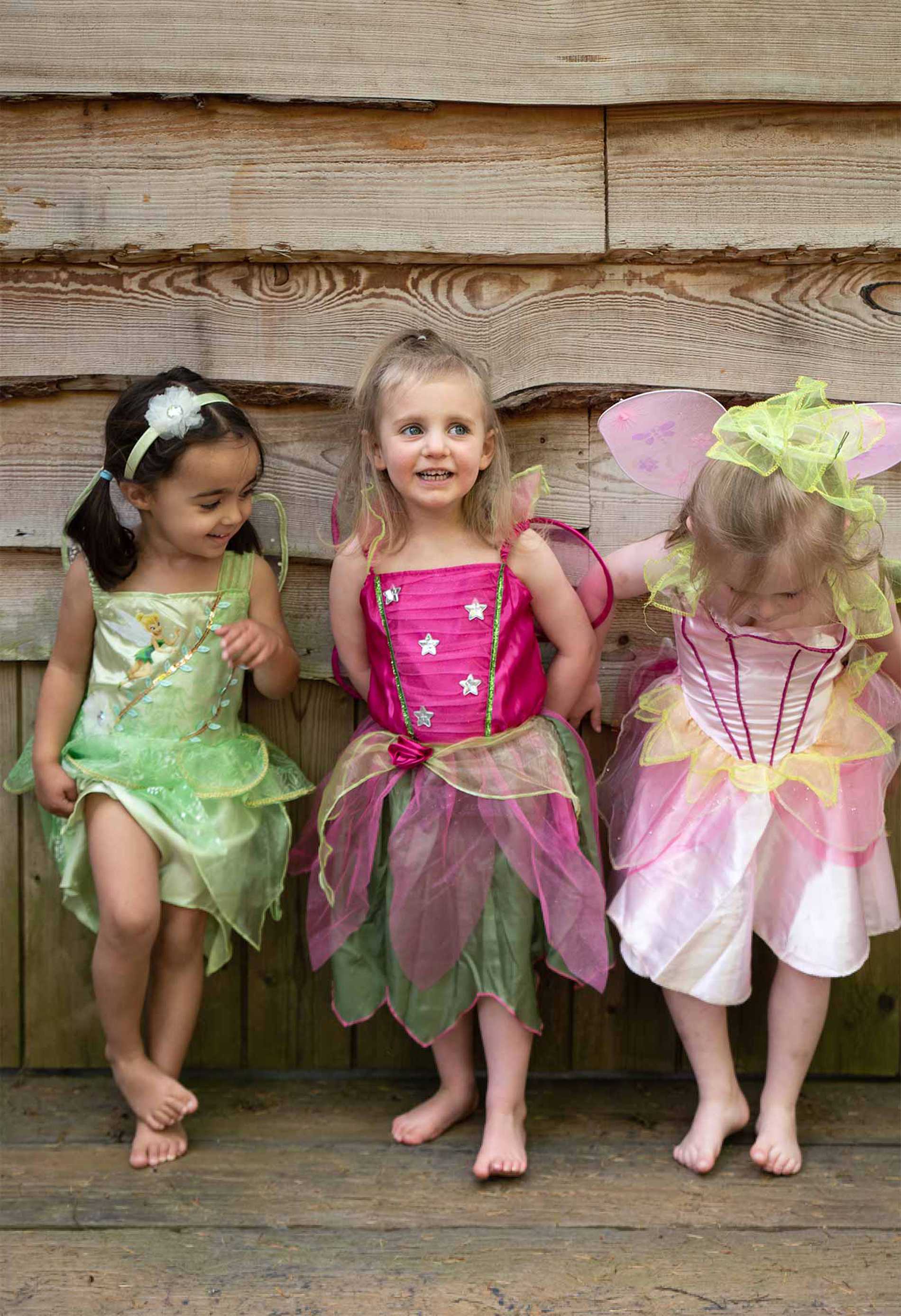 Elsie and her cousins standing outside the treehouse in their fairy costumes
