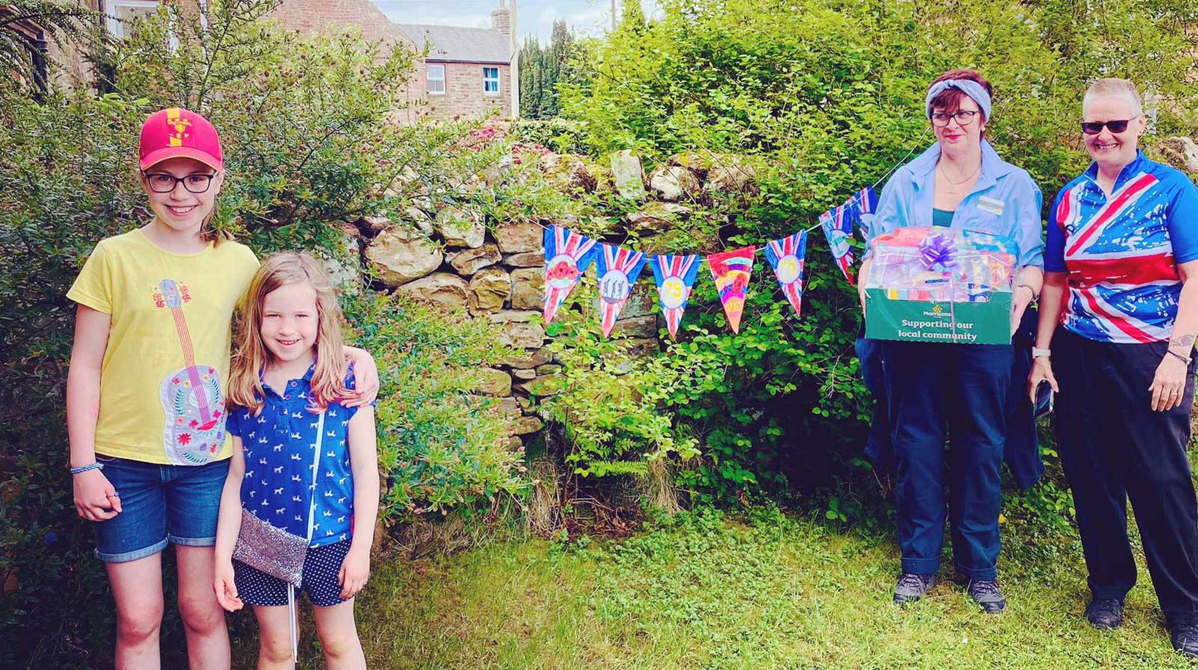 Wish child, Kate receiving her surprise gift from two Morrisons Community Champions.