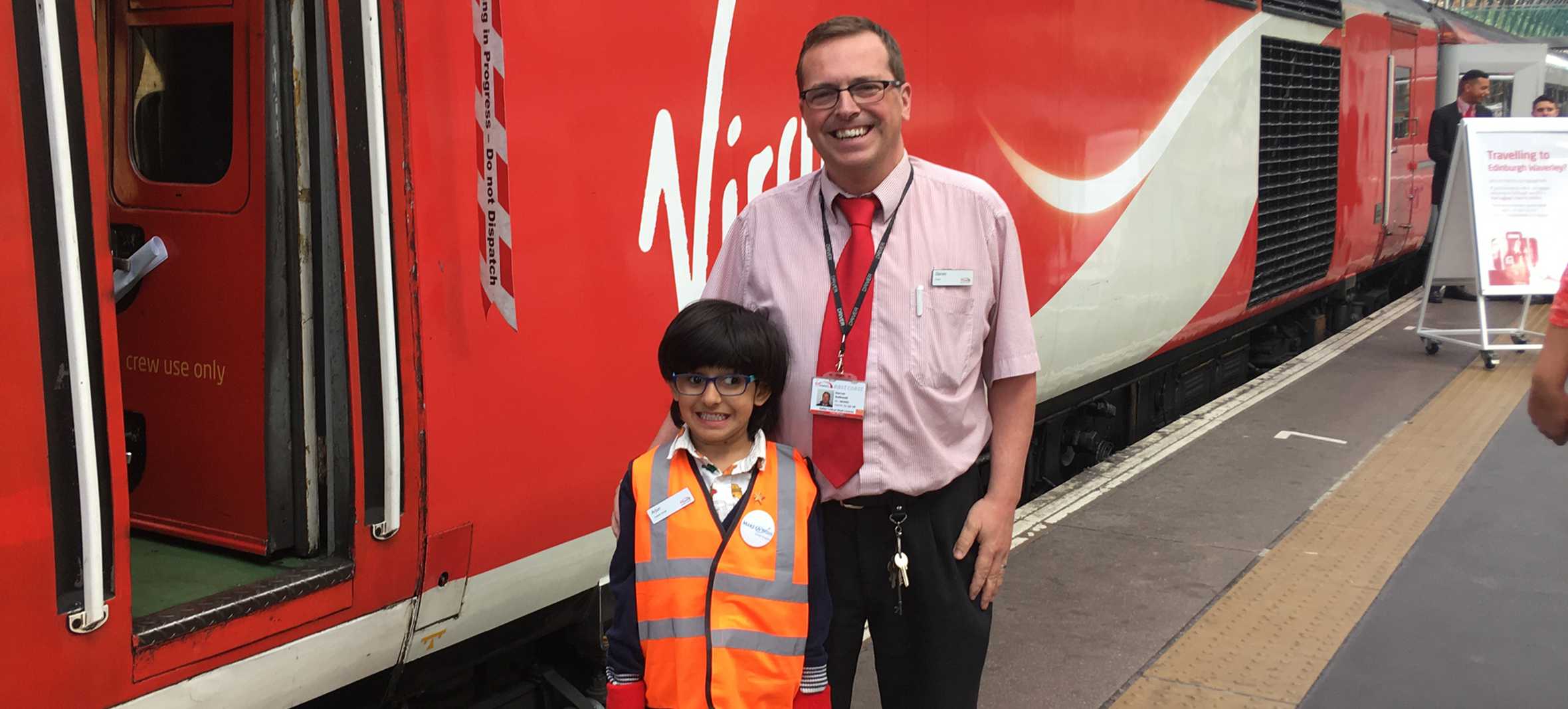 Arjun and a member of Virgin trains staff