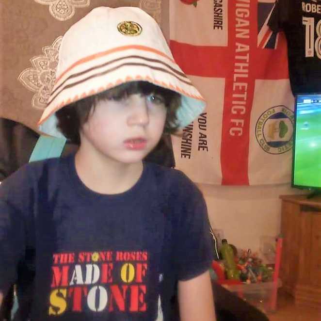 Alfie wearing a classic Stone Roses t-shirt and bucket hat.