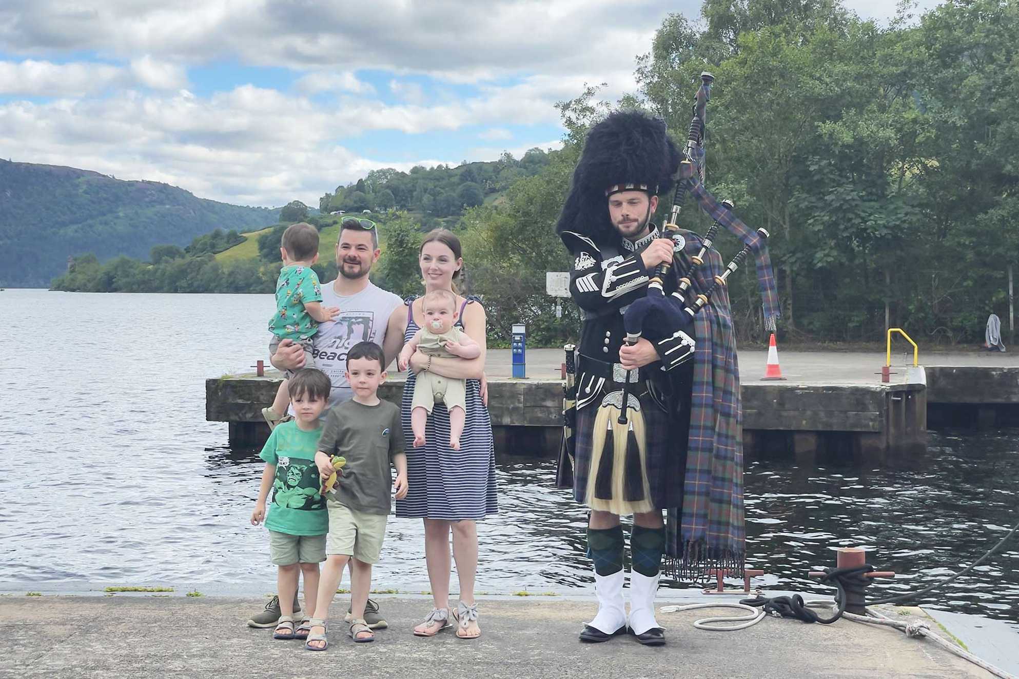 Harry and his family being welcomed by a traditional Scottish Piper.
