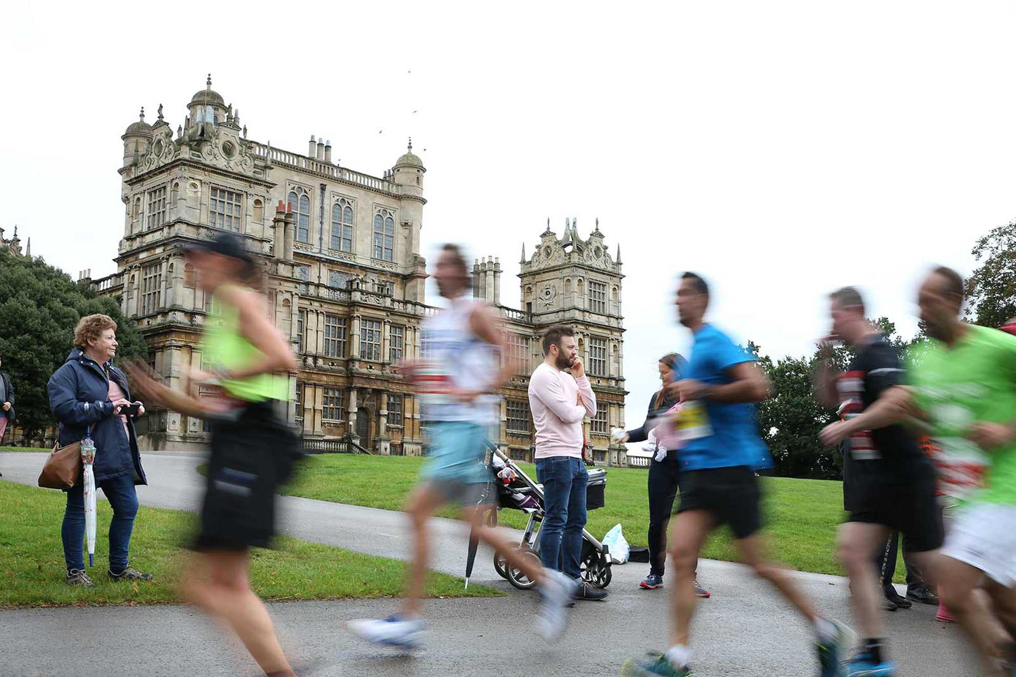 Runners passing Wollaton Hall during the Robin Hood Half Marathon in Nottingham.