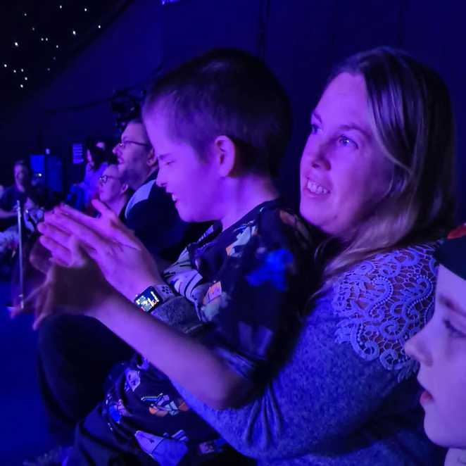 Lewis enjoying a show with his mums and sister, Lily-Grace, during his wish.