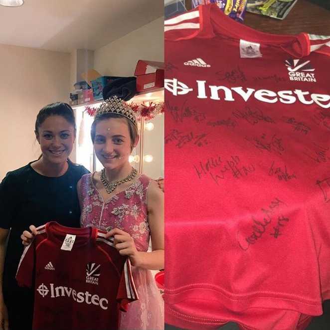 Lucy meeting Sam Quek, holding the signed England shirt she was given.