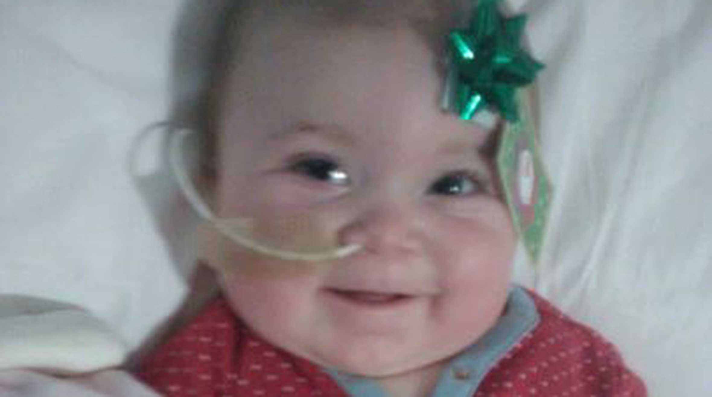 April in hospital with a bow on her head