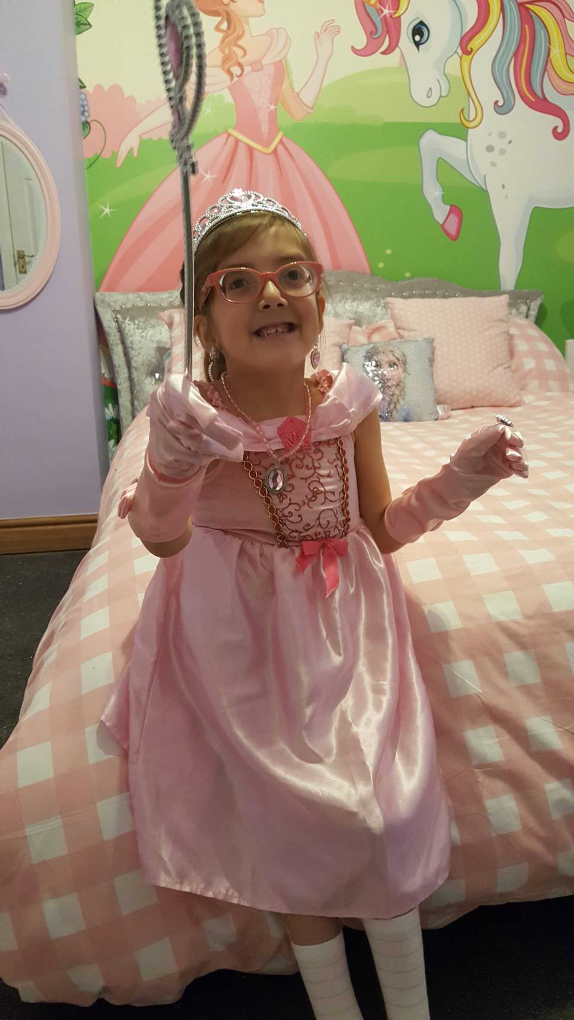 Smiling wish child, Tiara in her princess-themed bedroom.