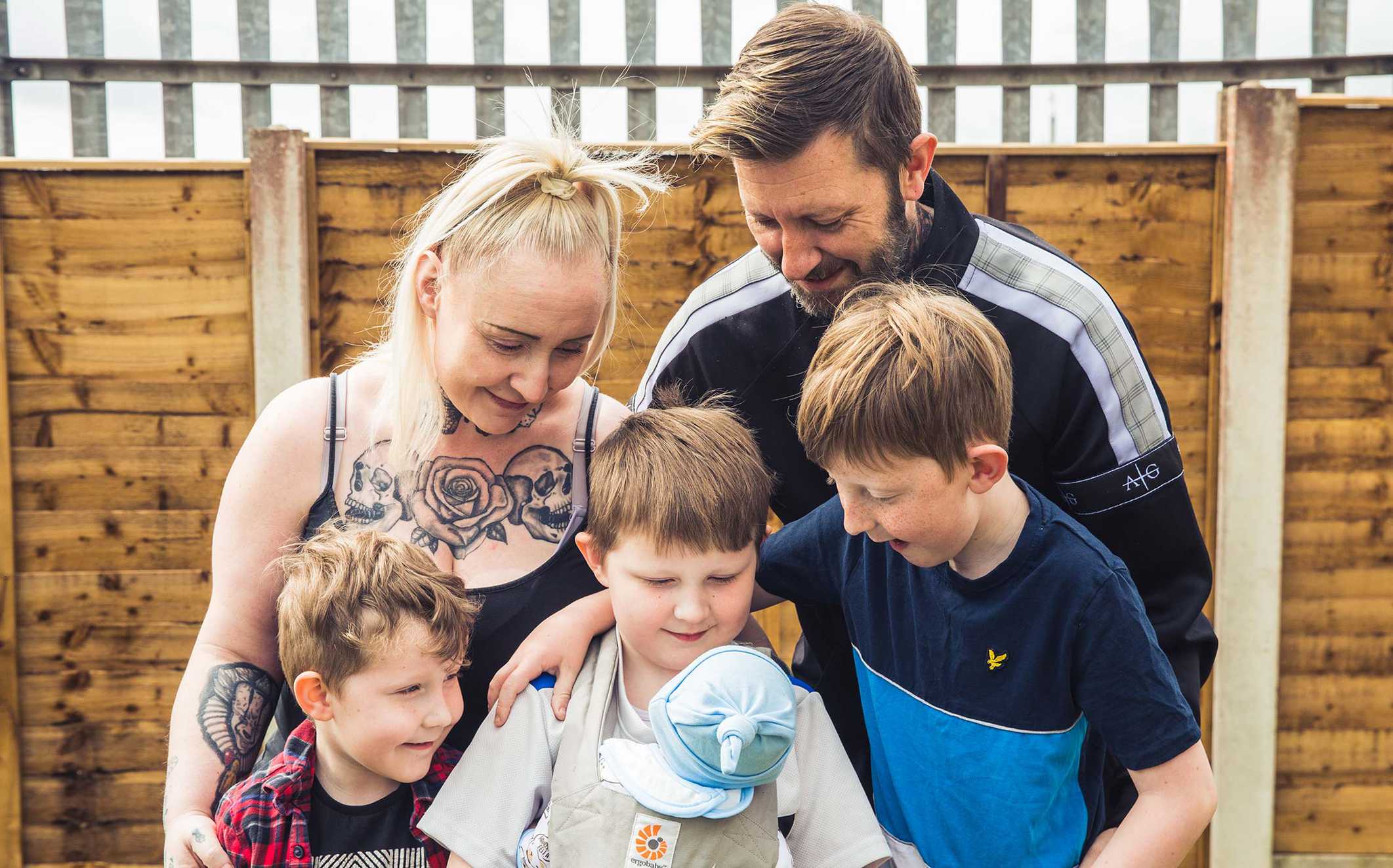 Andrew holding one of his 'babies' with his mum, dad and two brothers.