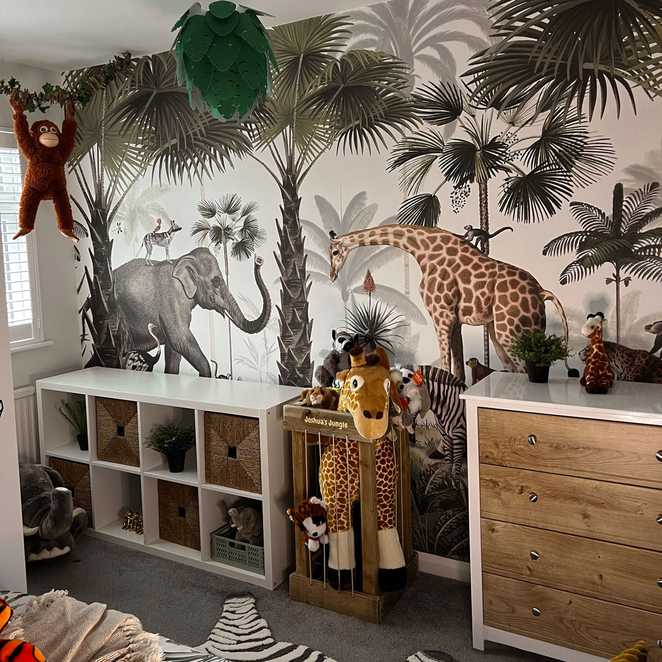 Joshua's new jungle themed wallpaper with all his plush animals including giraffe and a monkey.