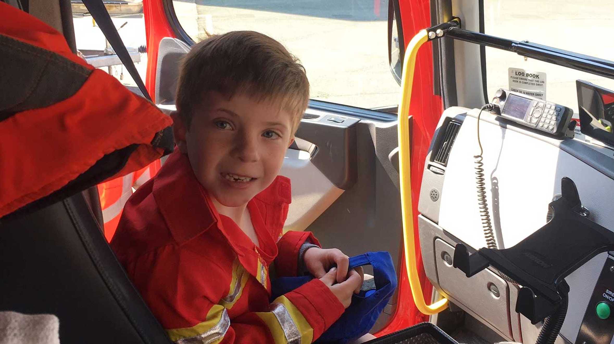 Wish child Jayden in a fire engine