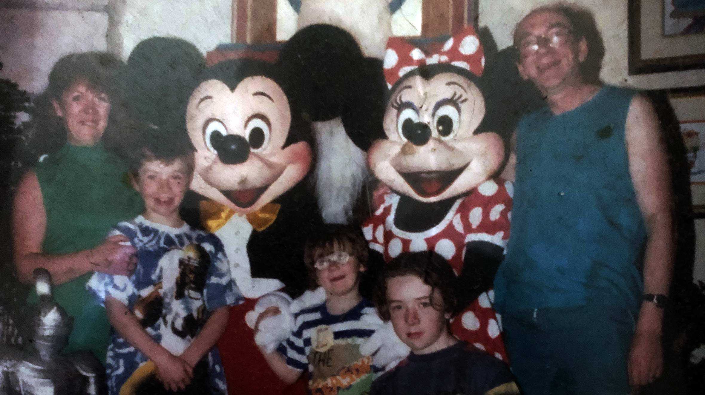 An old photo of Padraig and his family with Mickey and Minnie, during his brother's wish to visit Walt Disney World in Florida.