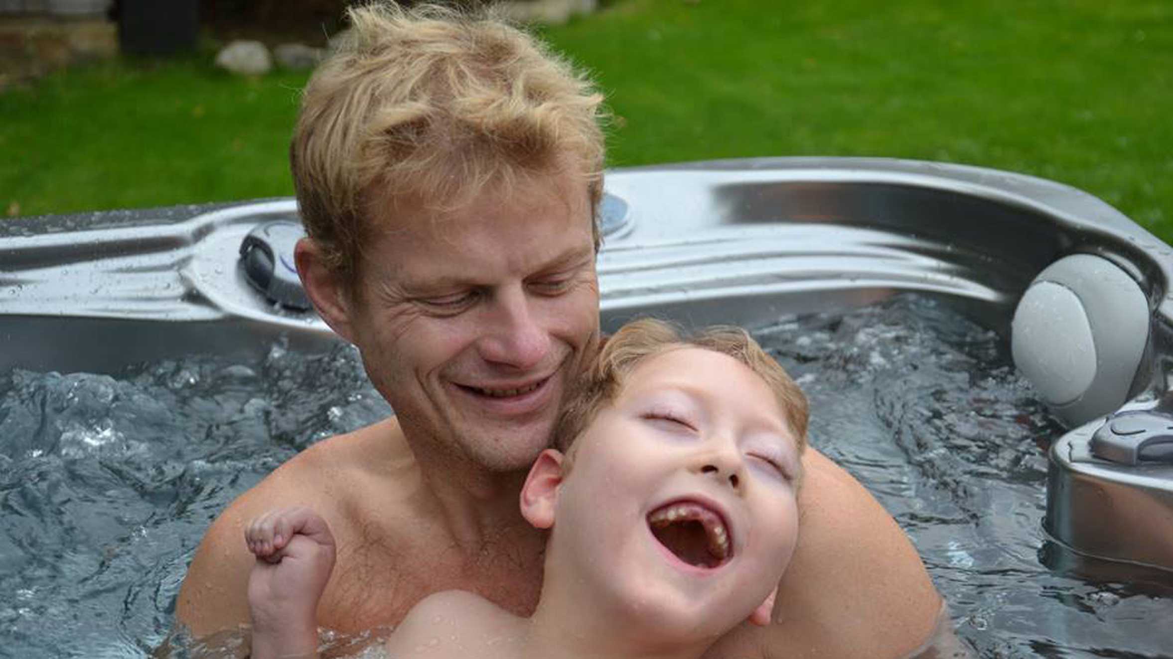 William enjoying the spa pool with his dad