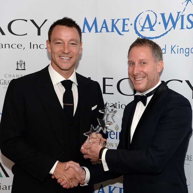 Oscar's dad, Matt presenting fottballer, John Terry a WishMaker Award for his support of Make-A-Wish UK.