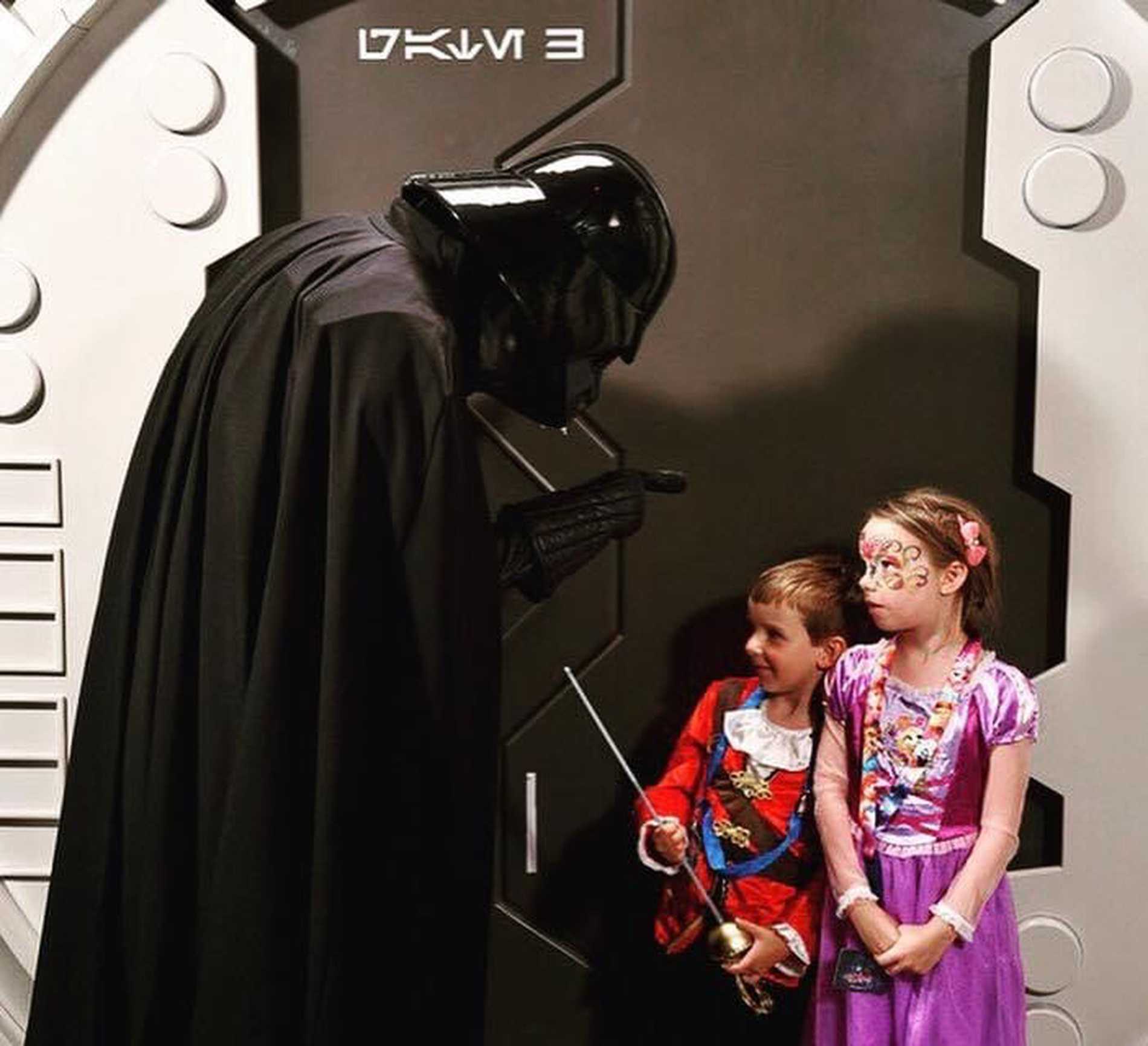 Isaac and his sister with Darth Vader.