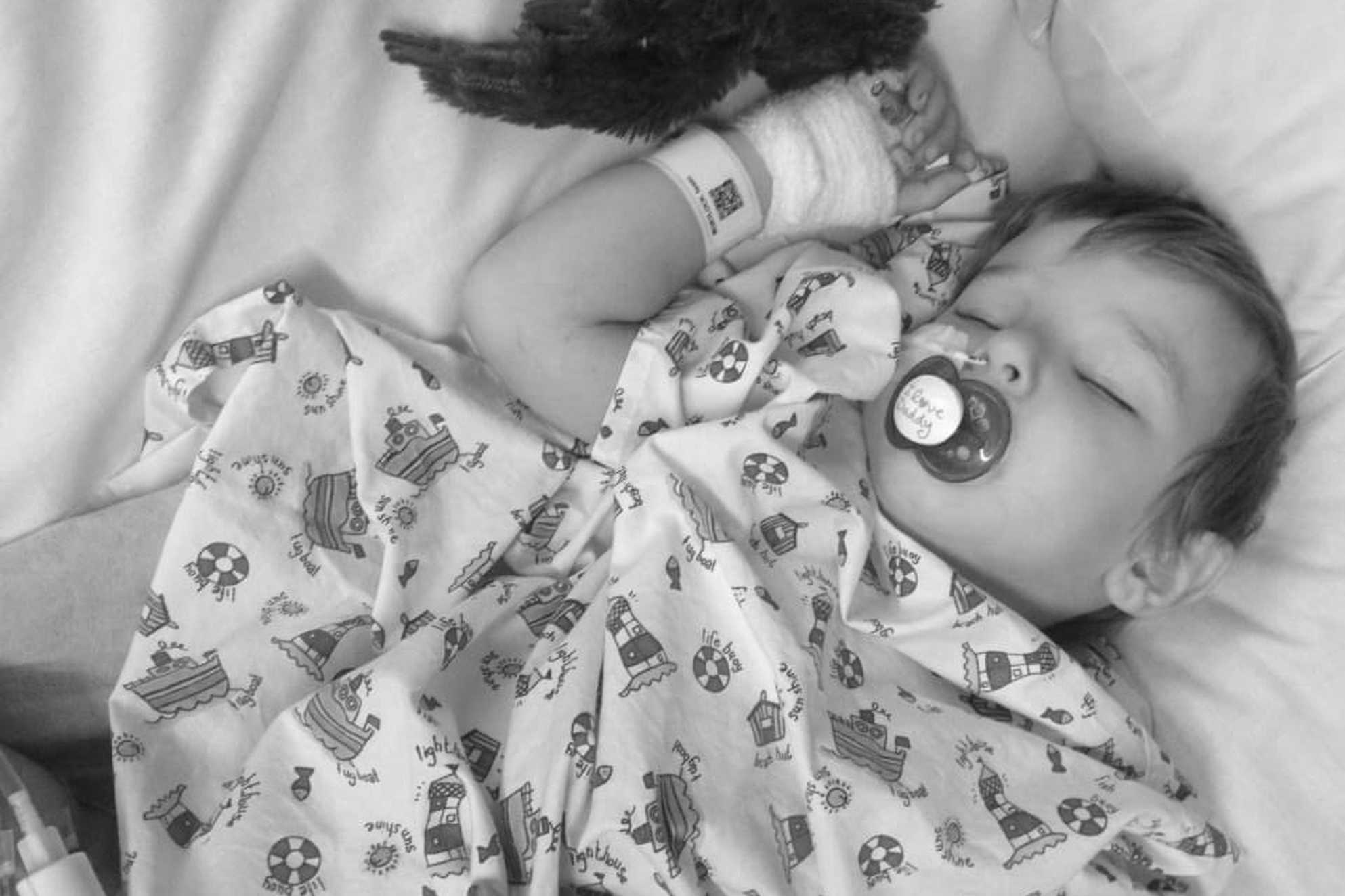 A black and white photo of Isaac in his hospital bed while undergoing treatment.