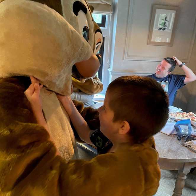 Lewis hugging one of the characters from Chip and Dale.