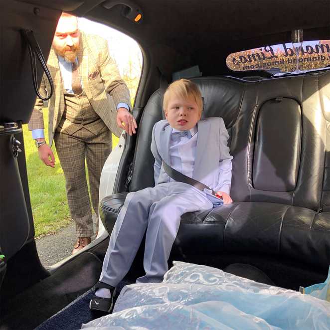 Jack in the back of the limo before heading to his prom, with dad in the background.