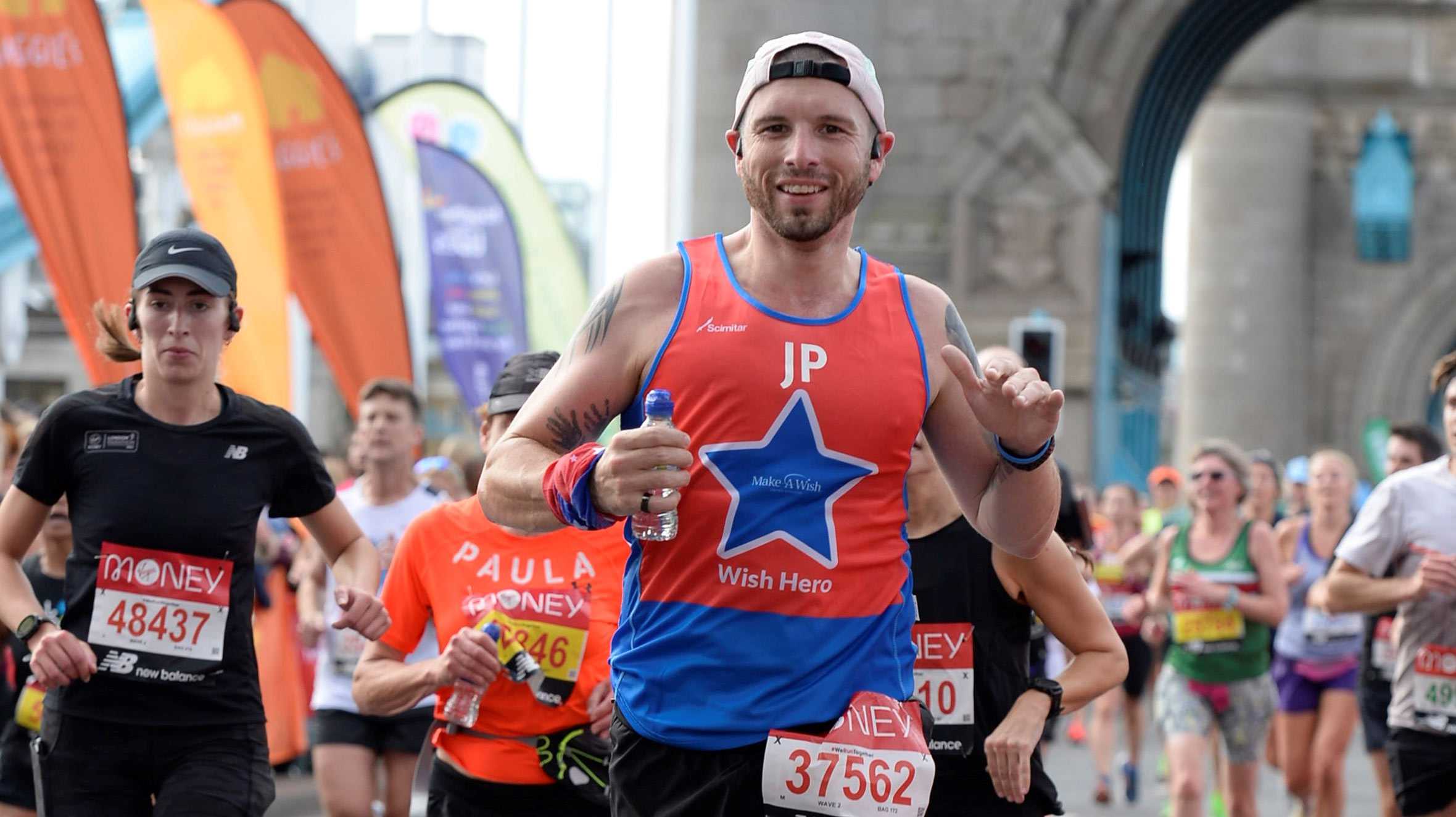 #WishHero, John running across Tower Bridge during the 2021 London Marathon.