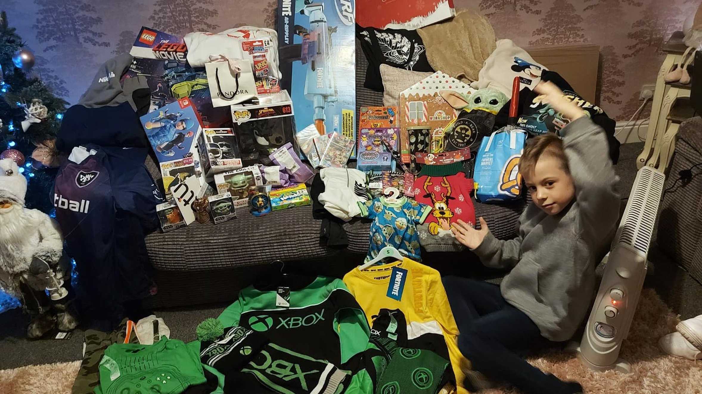 Alfie with his huge haul of toys and other goodies.