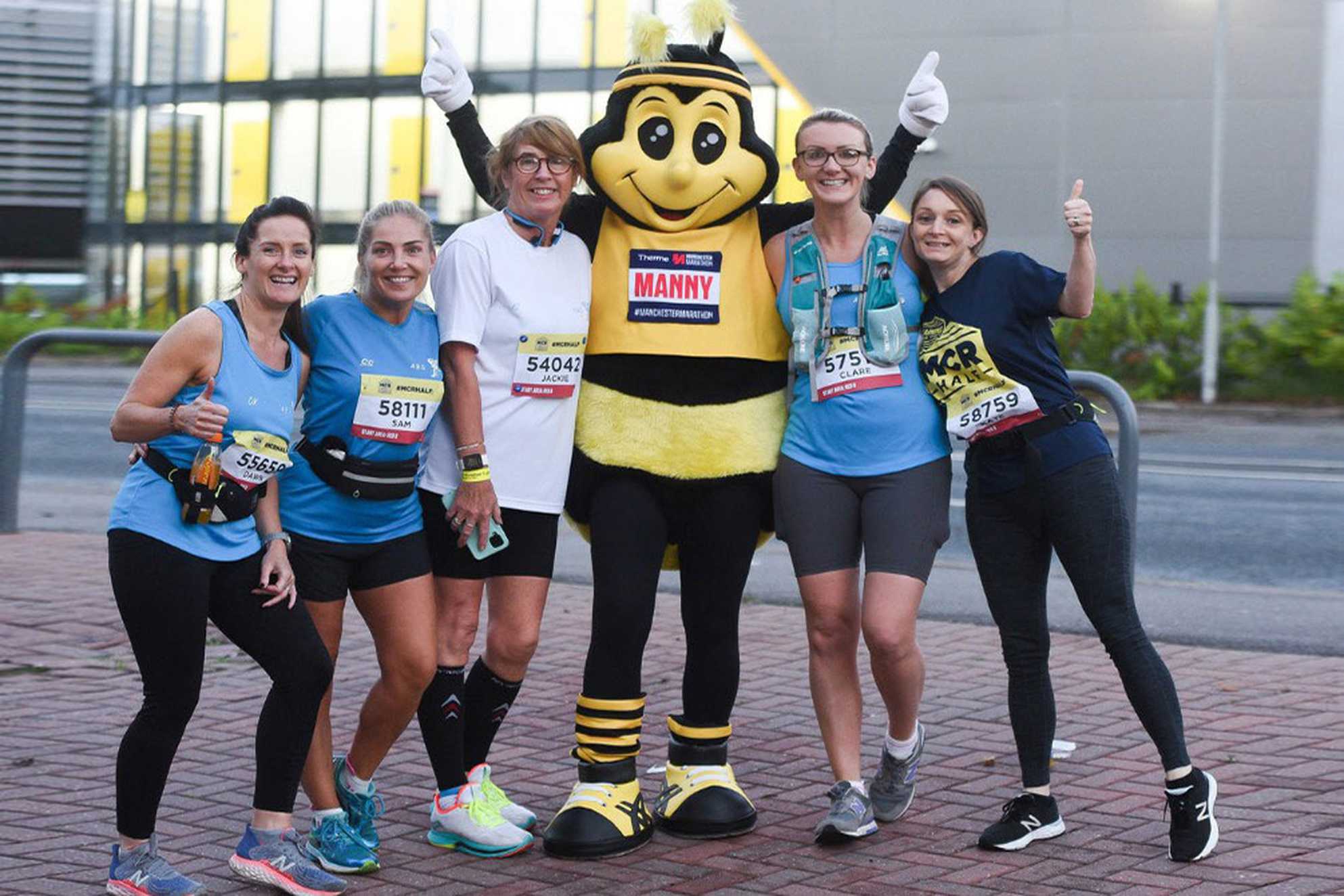 A group of Manchester half runners, including one wearing a bee costume.