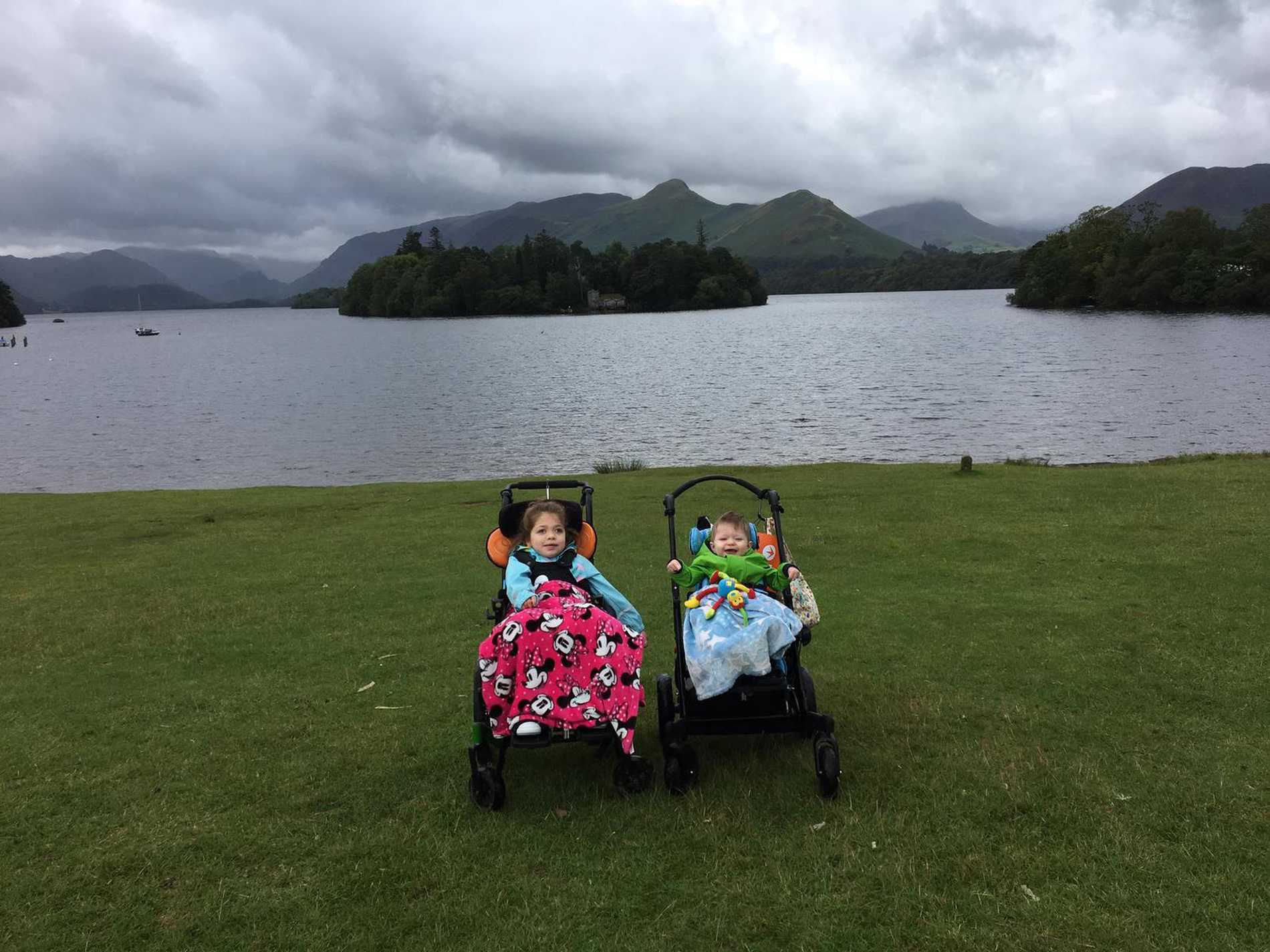 Aubree and her brother on the lake shore with the stunning Lake District scenery in the background.