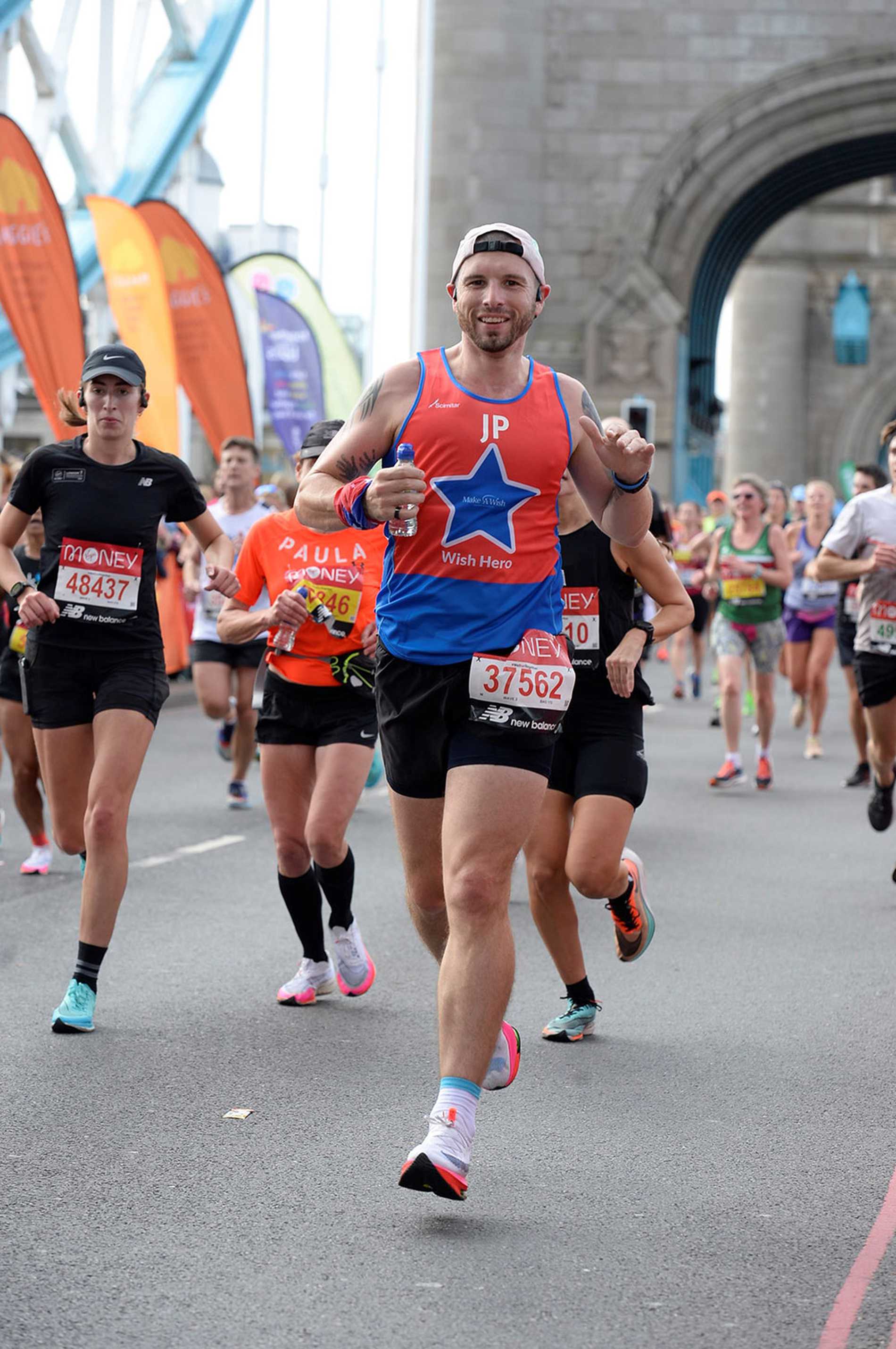 #WishHero, John running across Tower Bridge during the 2021 London Marathon.