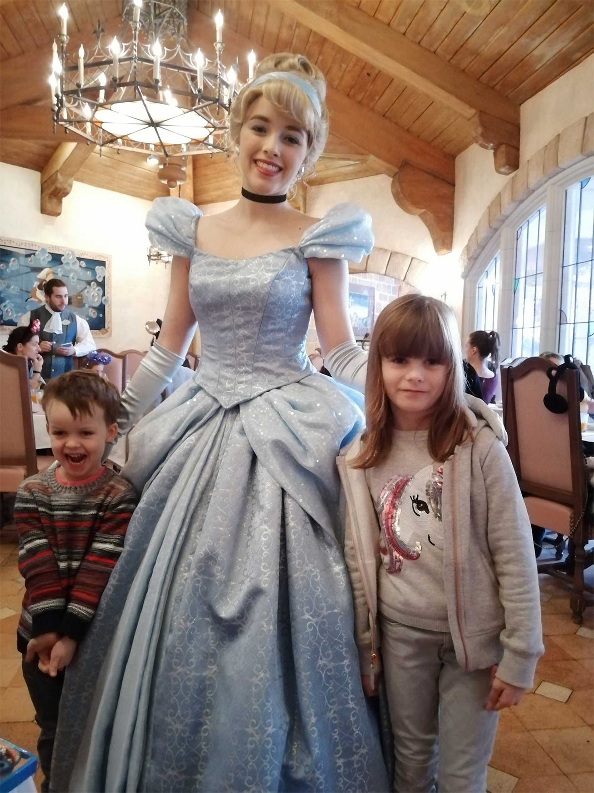 Ezekiel and his sister with a Disney princess.