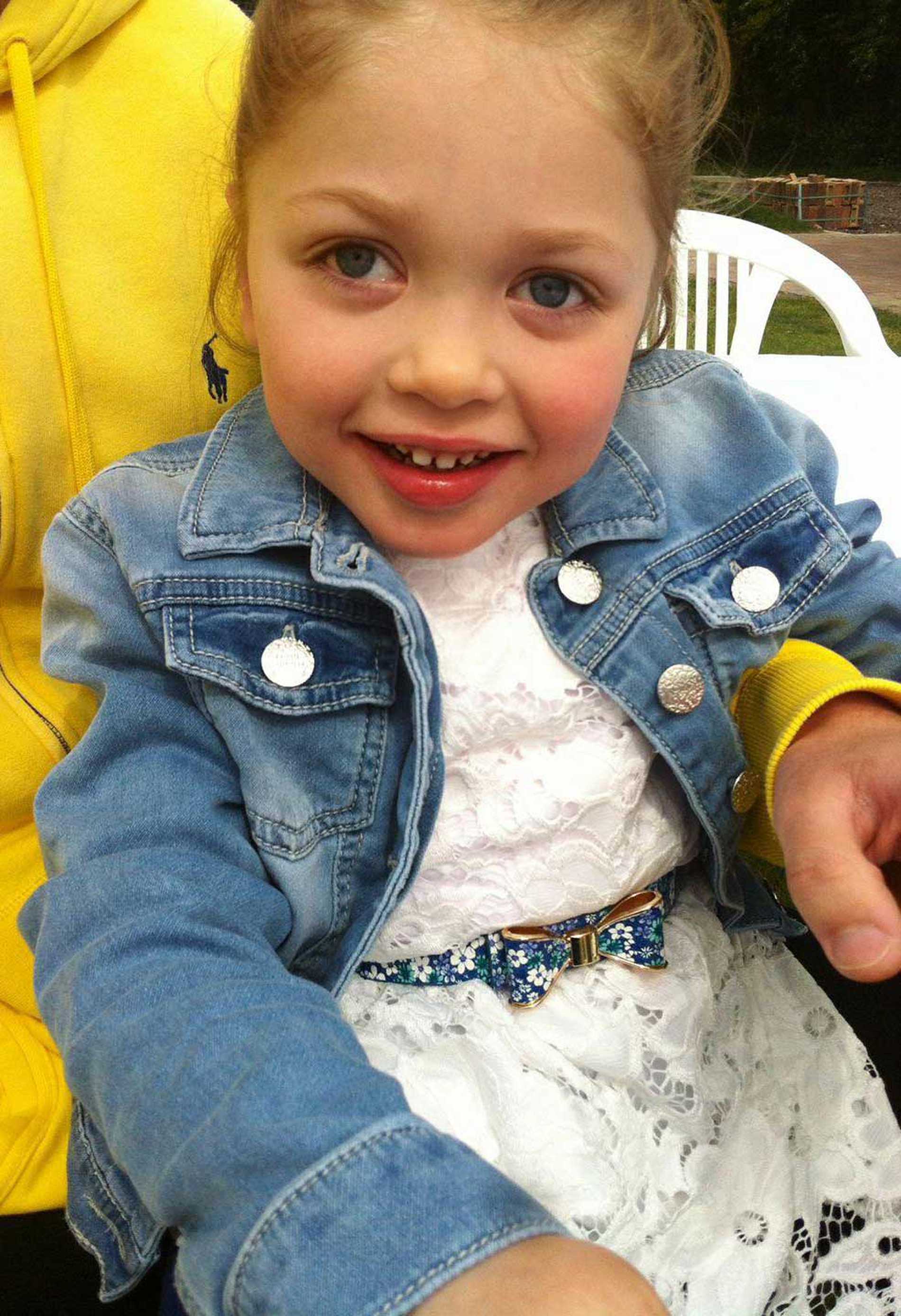 Aubree smiling in her dad's arms