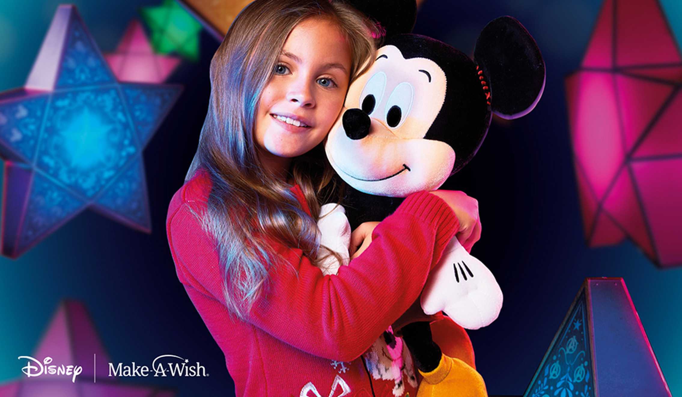A girl holding the Mickey Vintage Holiday Soft Toy.