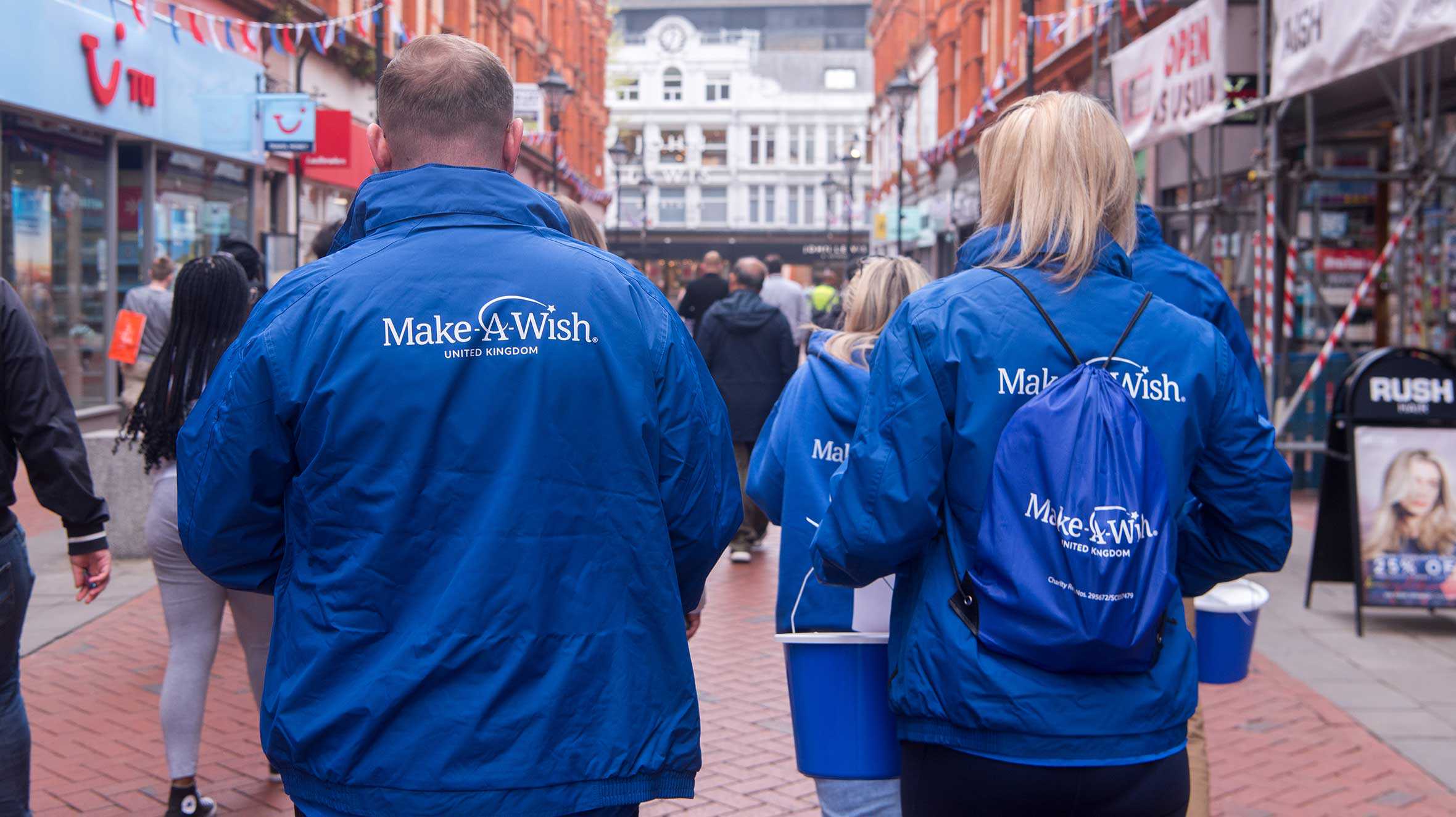Rear view of Make-A-Wish Team members fundraising on the streets of Reading.