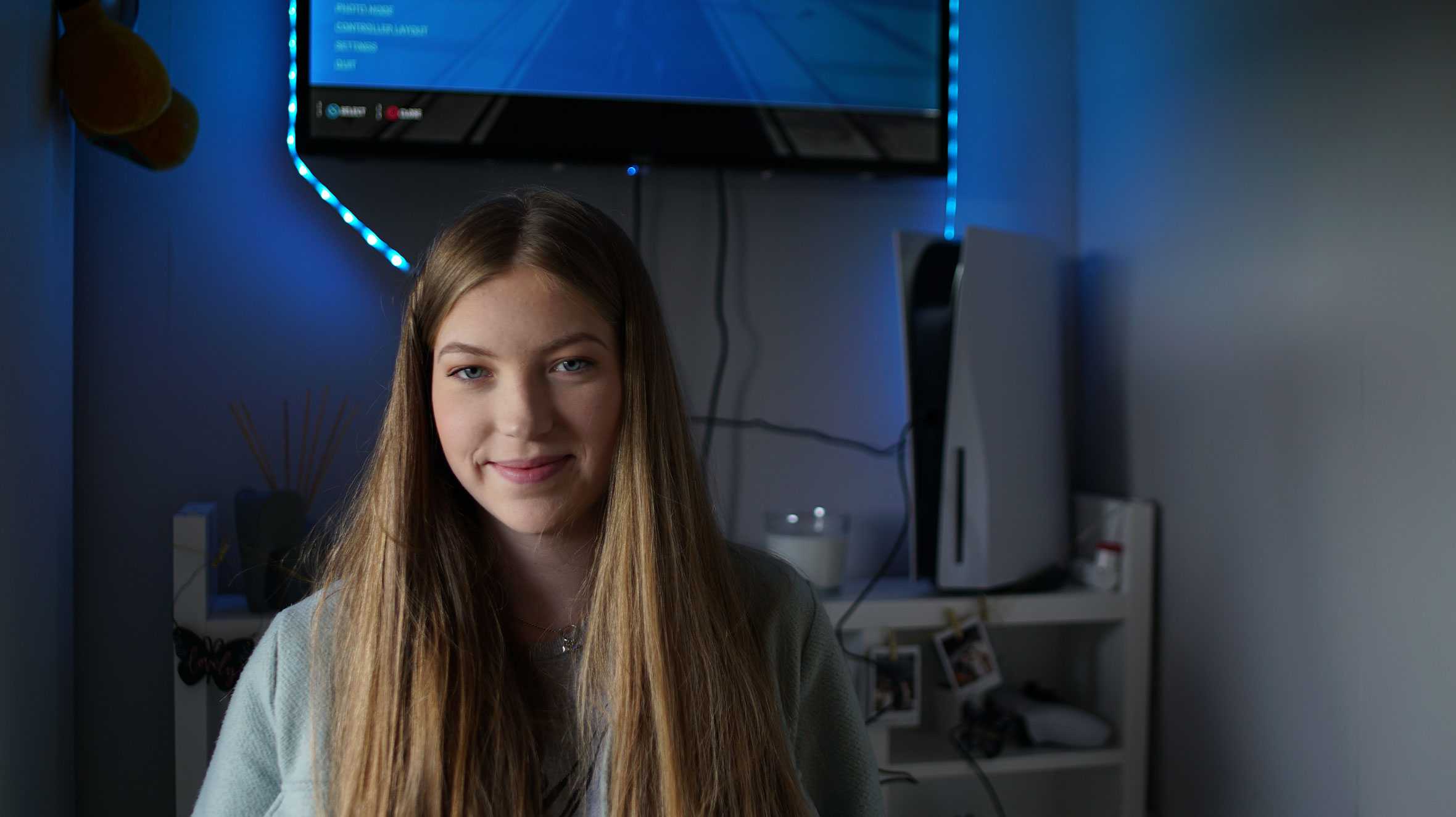 Hayley standing in front of her new gaming set up.