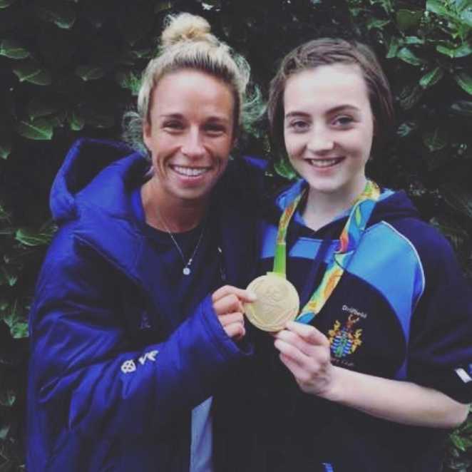 Lucy standing with Susannah Townsend and wearing her Olympic gold medal.