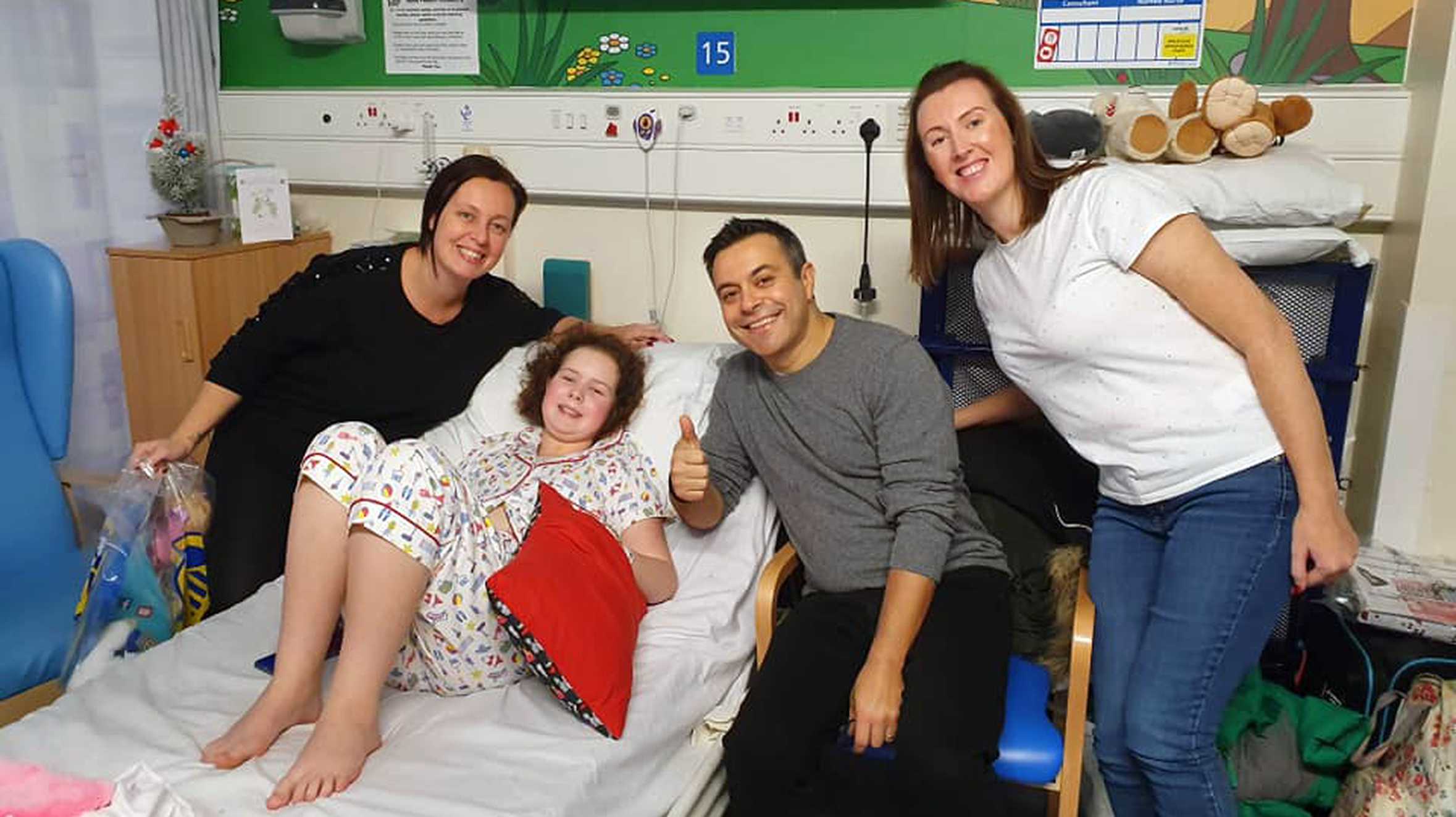 Natalie and Alex at Ruby's bedside in hospital during her treatment.