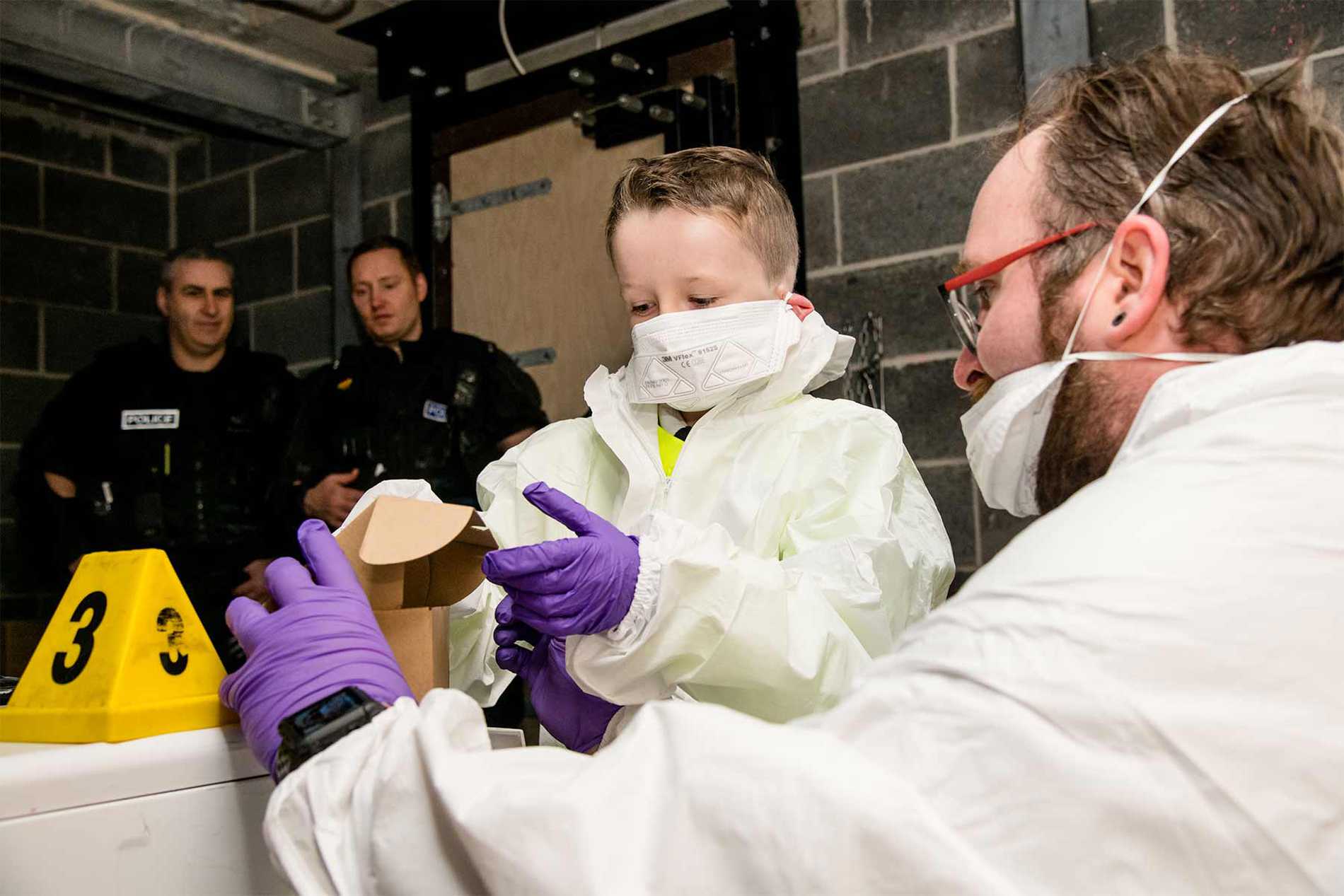 Allan investigating the scene of a crime with a scenes of crime officer.