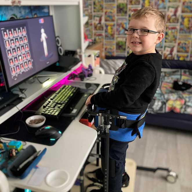 Harrison with the special braces that allow him to stand at his computer desk.