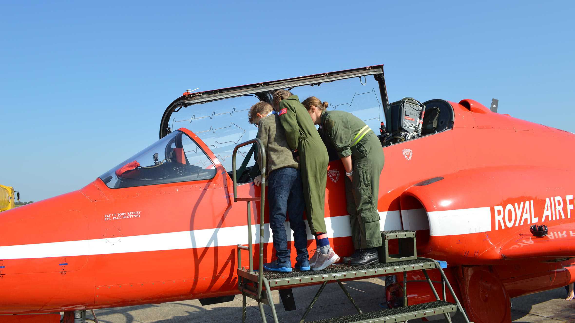 John and his sister being shown the cockpit by an RAF pilot.