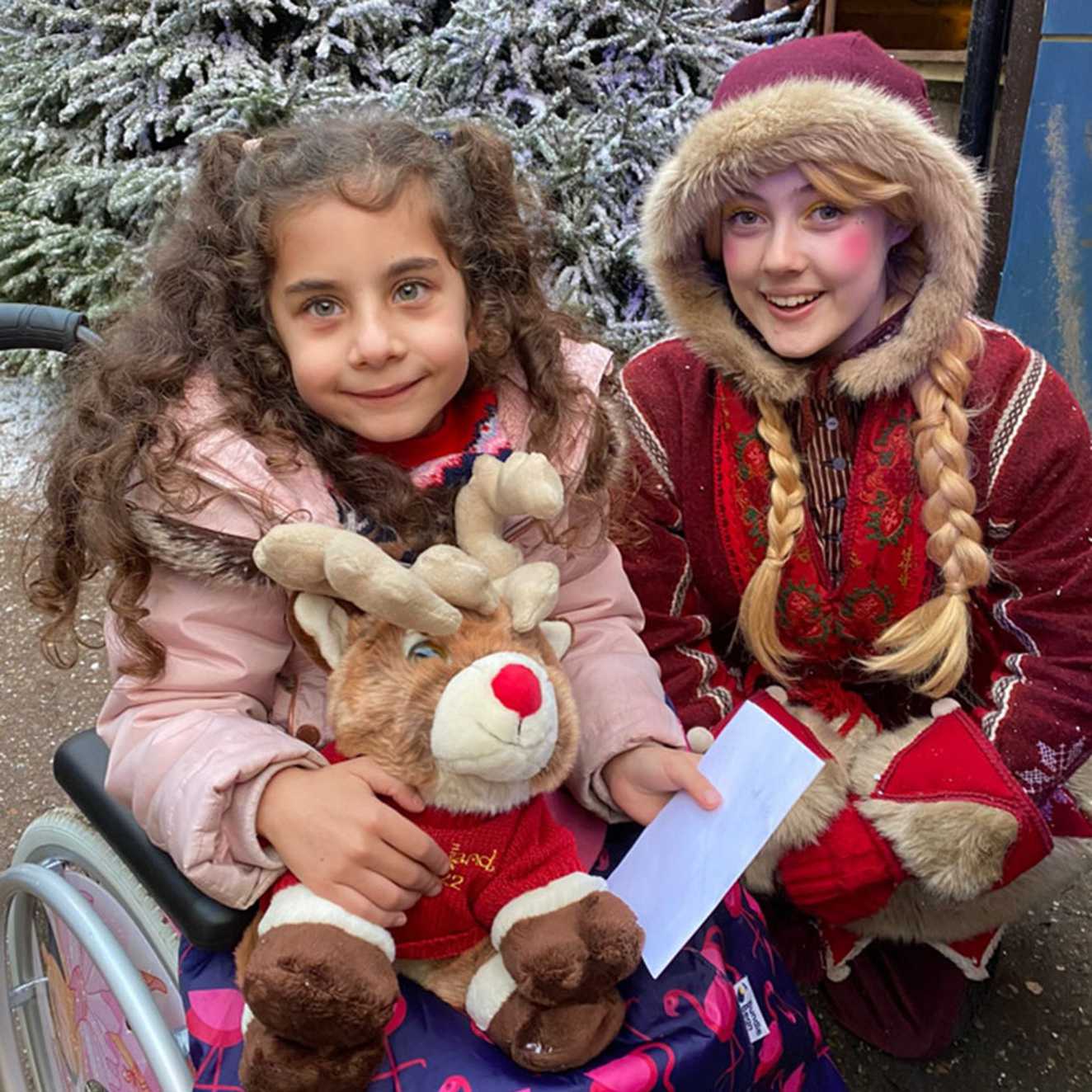 Riziah meeting one of Santa's helpers at Lapland UK.