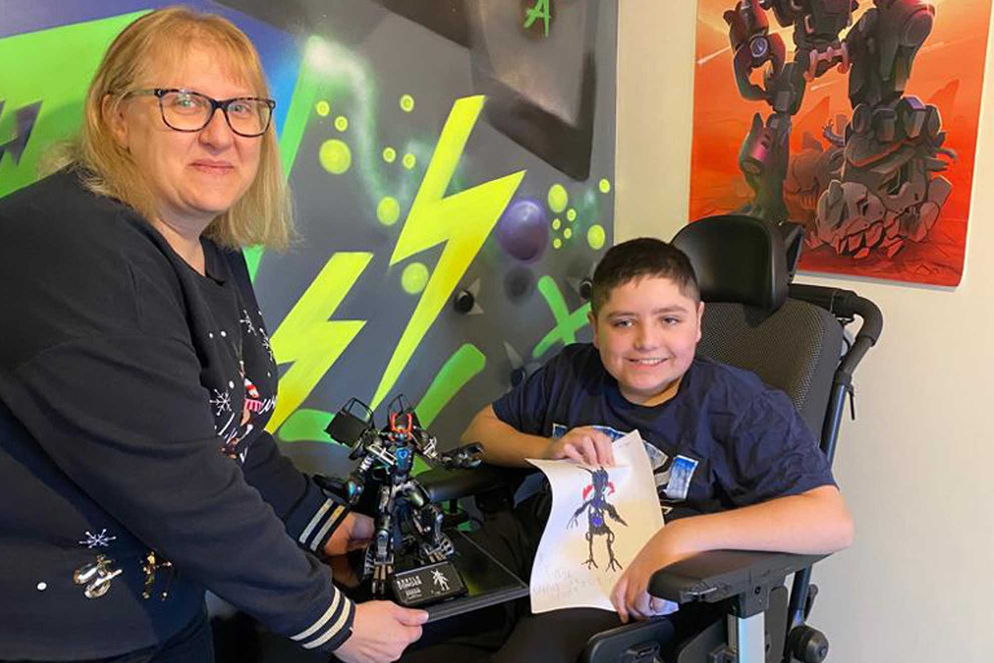 Kieran and his mum with his one-of-a-kind Beetle Stinger Transformer model.
