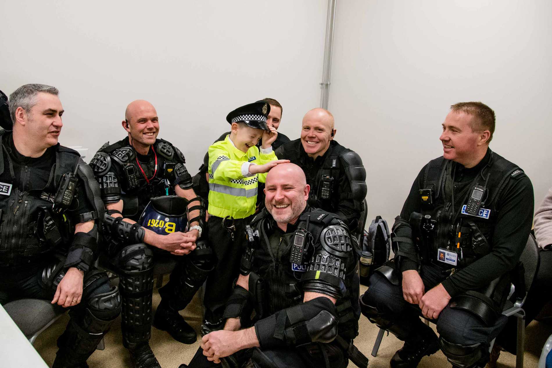 Allan laughing with a group of police officers during his wish.
